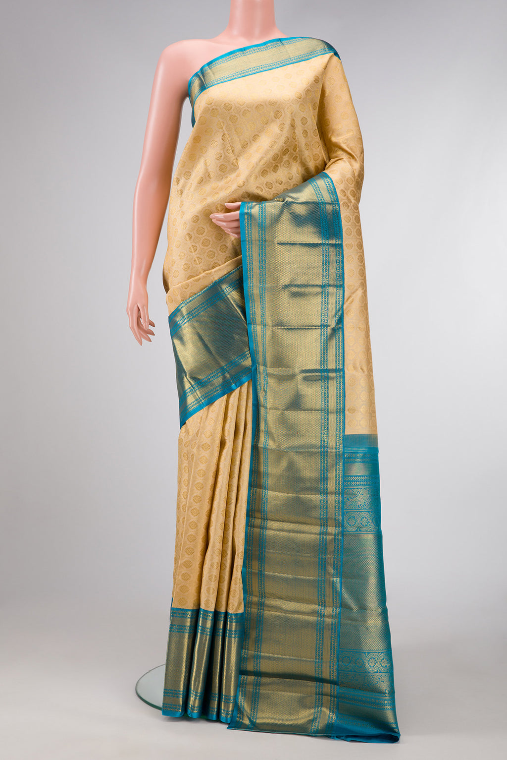 Pure Silk Pure Zari Beige Dual Tone Kanjivaram Saree with Zari Brocade on the body and Zari Border.  displayed on a mannequin
