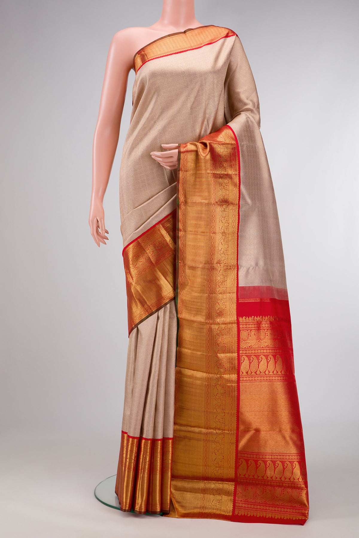 Pure Silk Pure Zari Rose Gold Dual Tone Kanjivaram Saree with Zari Brocade on the body and Zari Border.  displayed on a mannequin