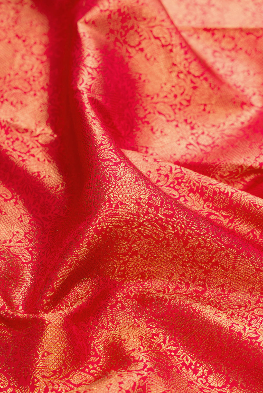 Close up of Pure Silk Pure Zari Red Dual Tone Kanjivaram Saree with Zari Brocade on the body and Zari Border.  displaying folds