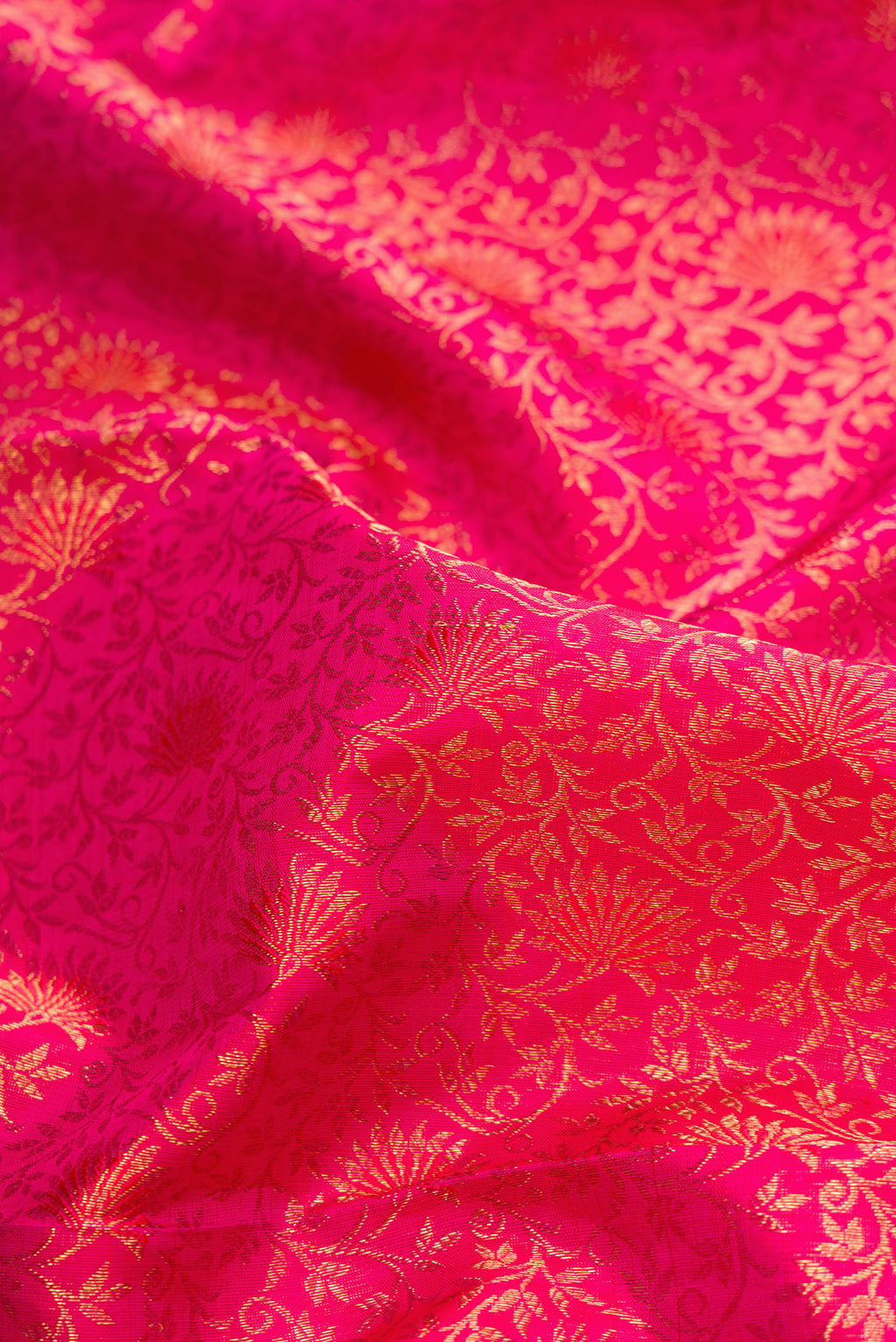 Close up of Pure Silk Pure Zari Pink Dual Tone Kanjivaram Saree with Zari Brocade on the body and Zari Border.  displaying folds