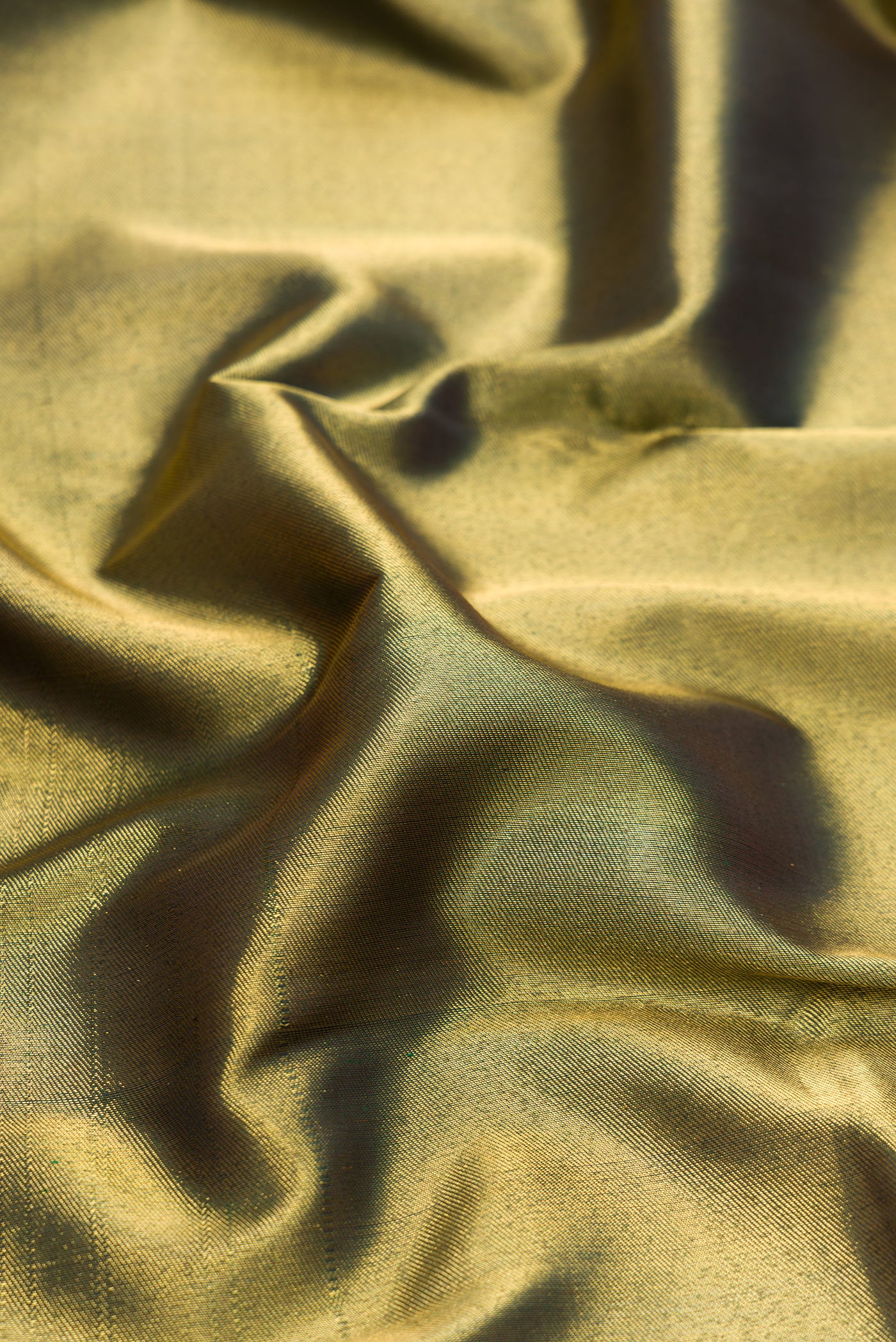 Close up of Pure Silk Pure Zari Bottle Green Dual Tone Kanjivaram Saree with Zari Brocade on the body and Fancy Border.  displaying folds