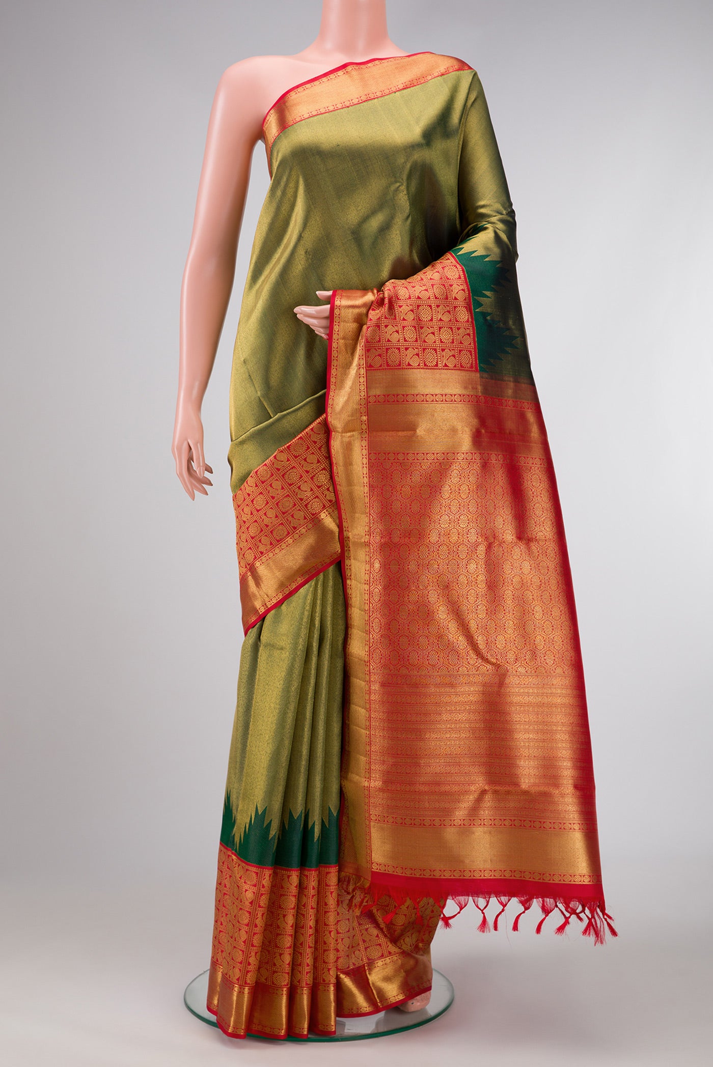 Pure Silk Pure Zari Bottle Green Dual Tone Kanjivaram Saree with Zari Brocade on the body and Fancy Border.  displayed on a mannequin