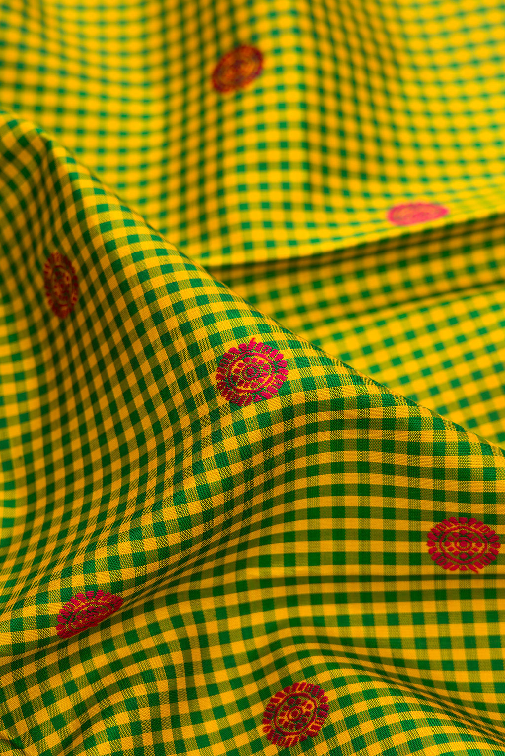 Close up of Pure Silk Pure Zari Green Kanjivaram Saree with Checked design on the body and Zari Border.  displaying folds