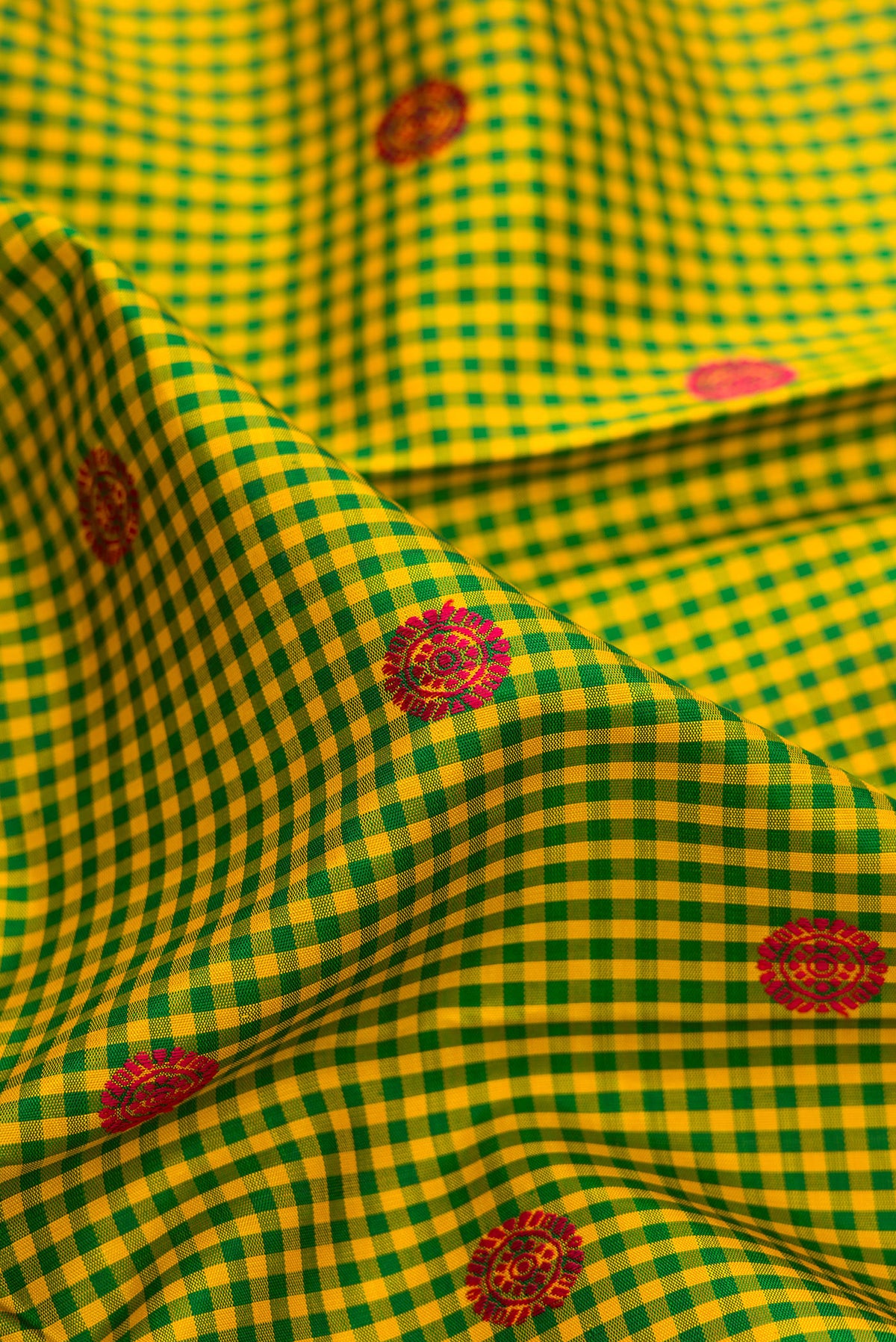 Close up of Pure Silk Pure Zari Green Kanjivaram Saree with Checked design on the body and Zari Border.  displaying folds