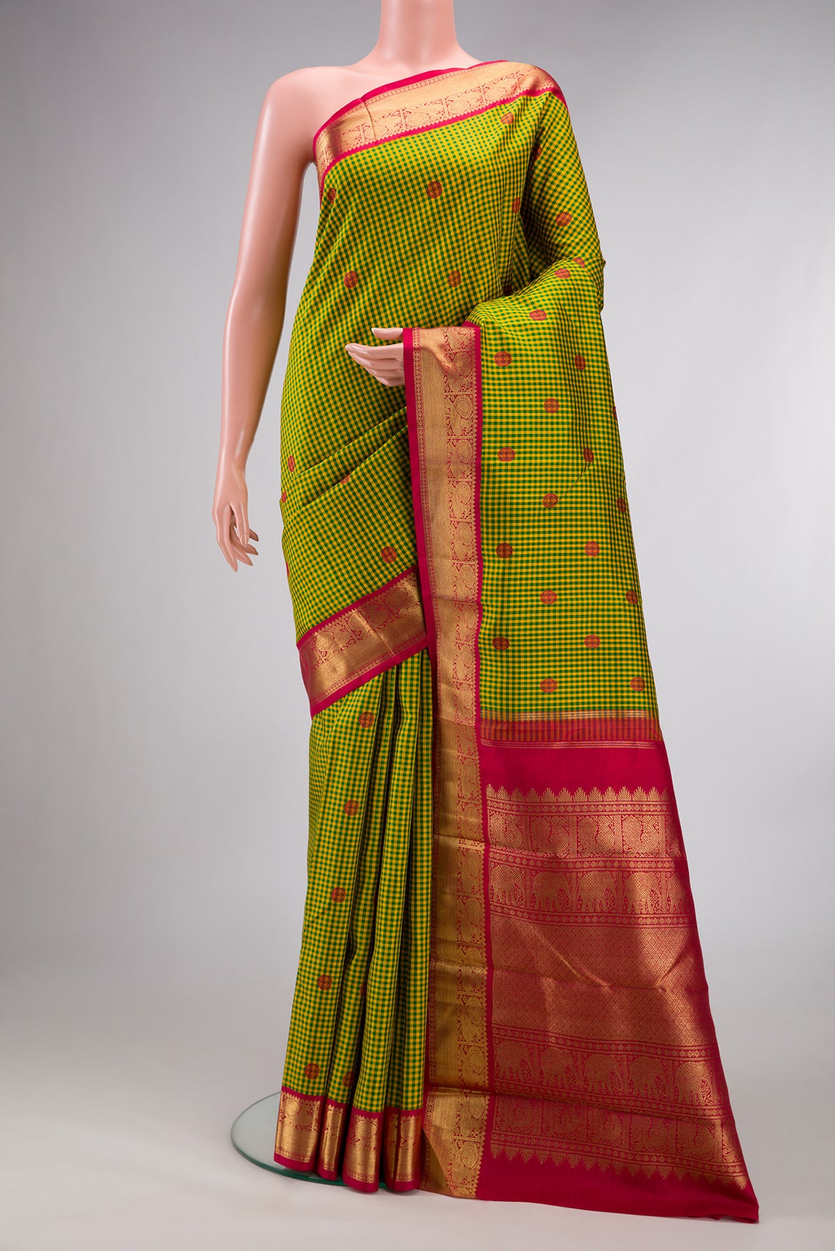 Pure Silk Pure Zari Green Kanjivaram Saree with Checked design on the body and Zari Border.  displayed on a mannequin