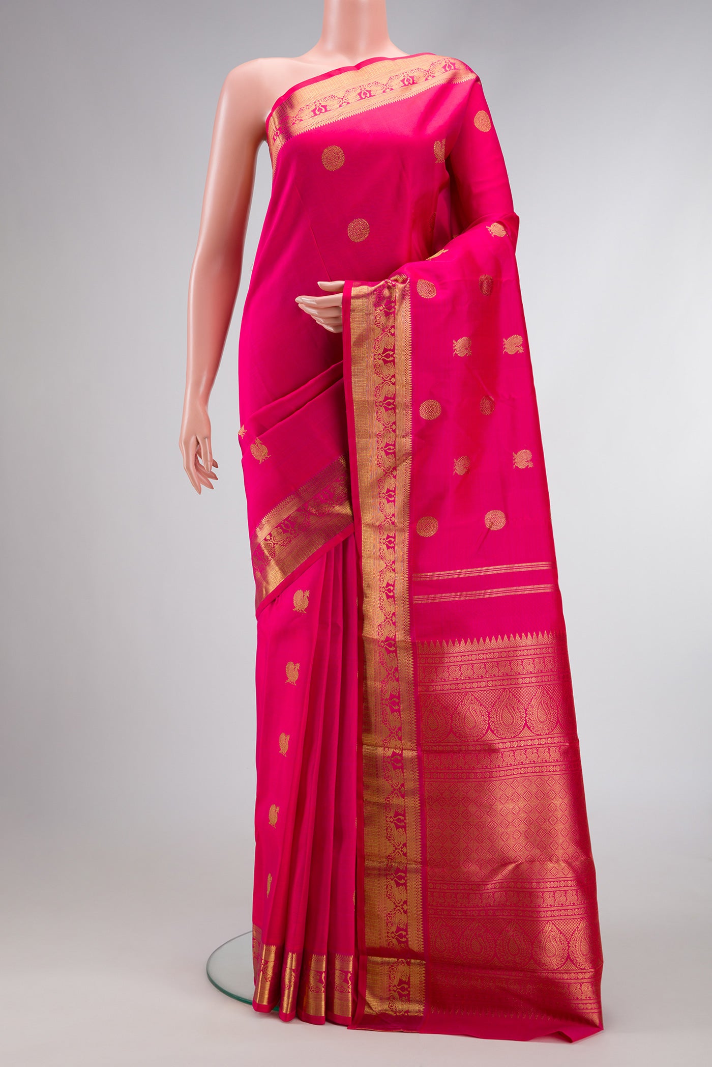 Pure Silk Pure Zari Dark Pink Dual Tone Kanchipuram Saree with Zari Butta on the body and Zari Border.  displayed on a mannequin