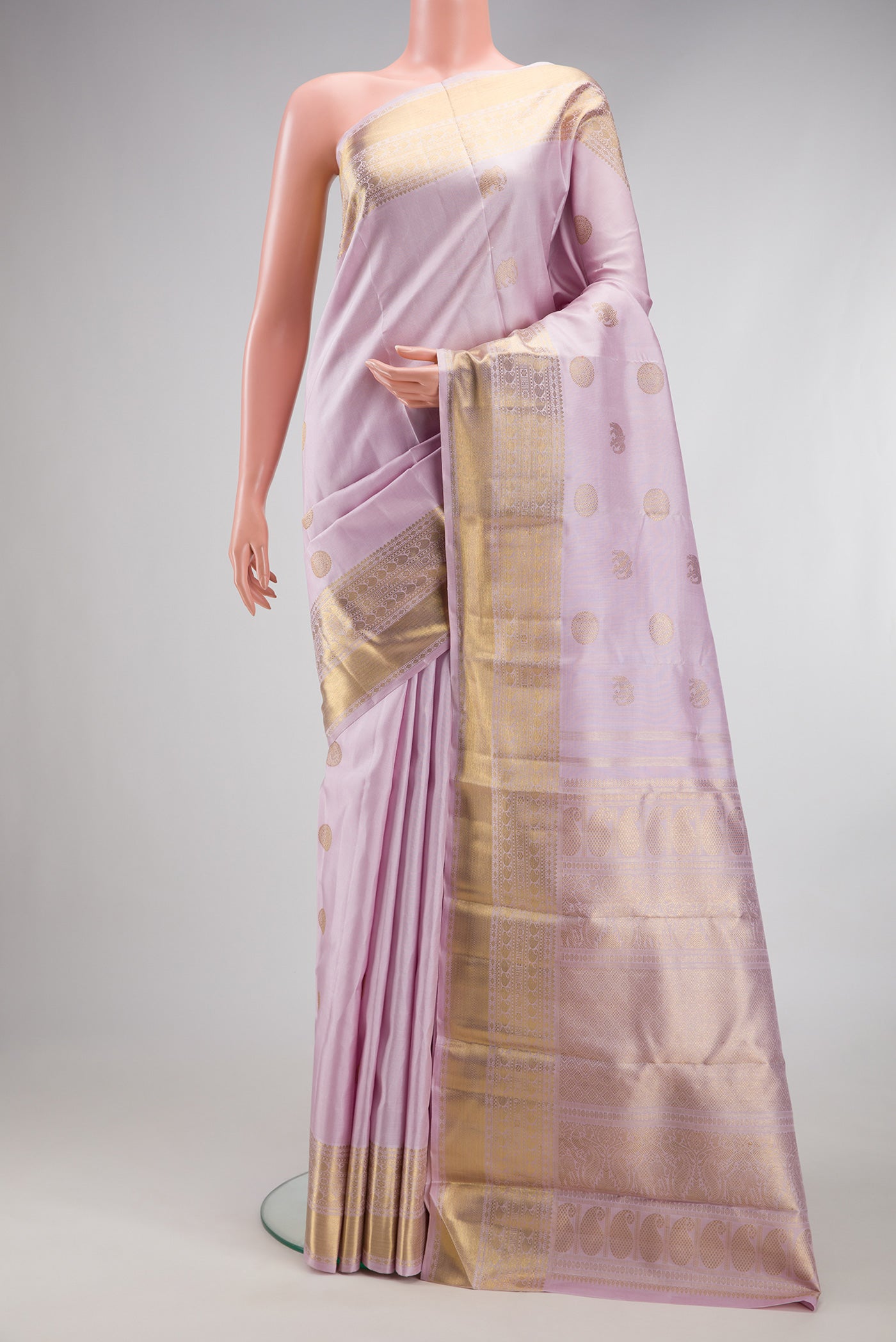 Pure Silk Pure Zari Lavender Kanjivaram Saree with Zari Butta on the body and Zari Border.  displayed on a mannequin