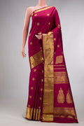 Pure Silk Pure Zari Maroon Kanjivaram Saree with Zari Butta on the body and Zari Border.  displayed on a mannequin