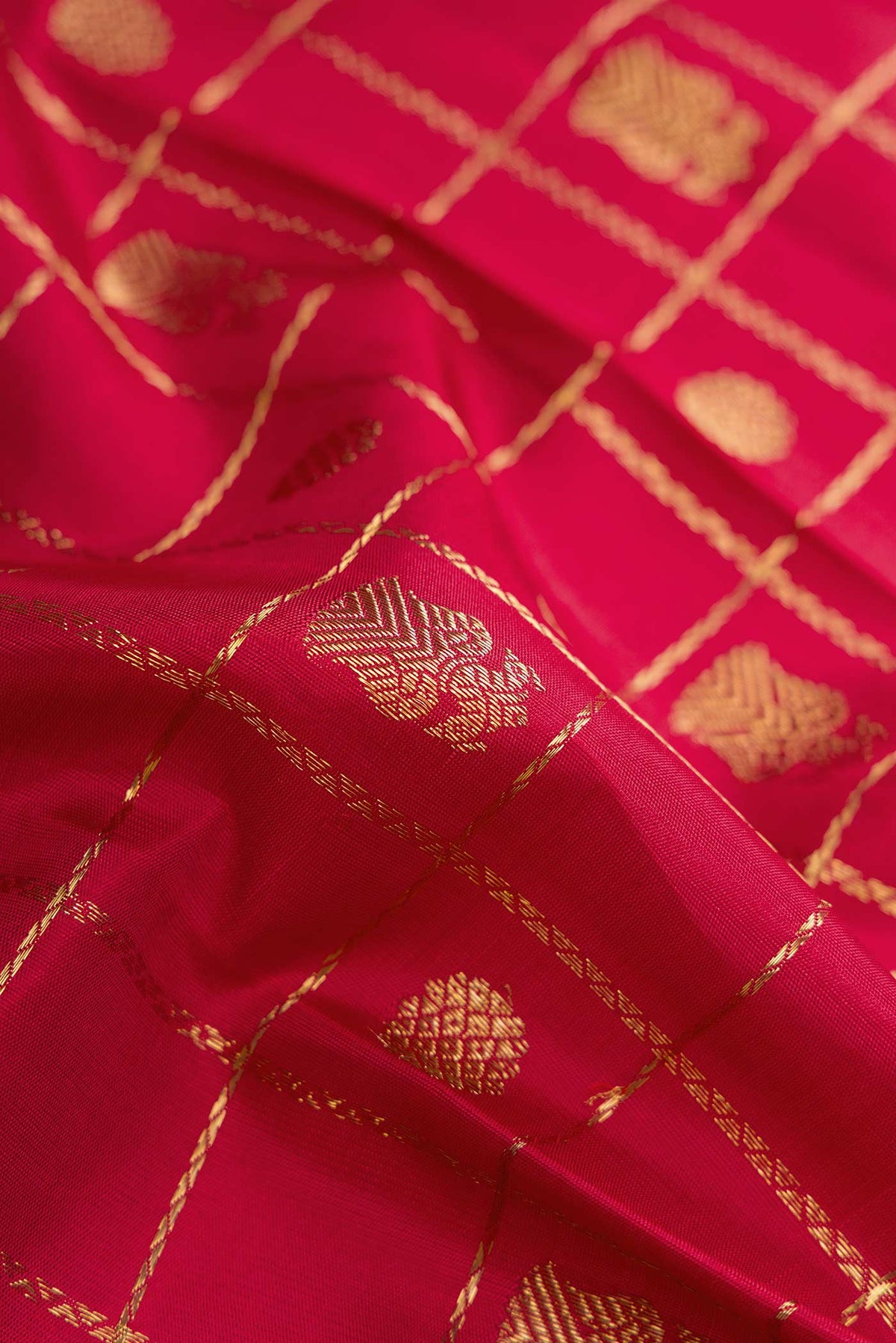 Close up of Pure Silk Pure Zari Maroon Dual Tone Kanchipuram Saree with Checked design on the body and Zari Border displaying folds