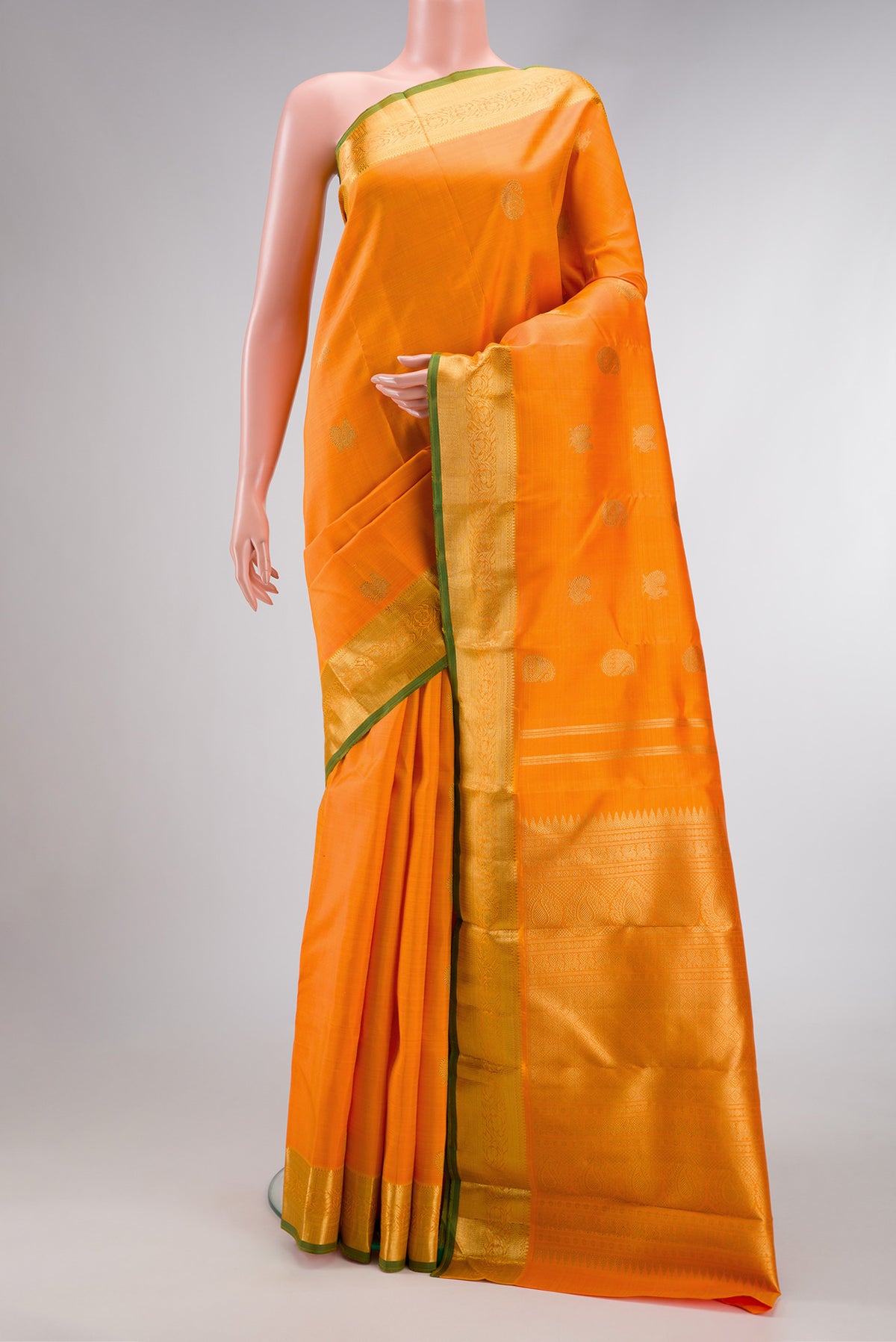 Pure Silk Pure Zari Orange Dual Tone Kanchipuram Saree with Zari Butta on the body and Zari Border.  displayed on a mannequin
