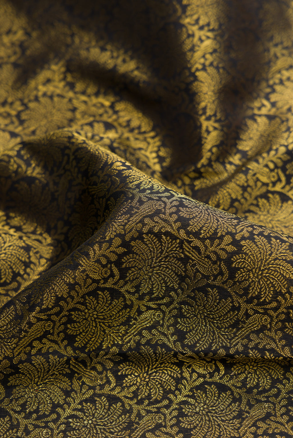 Close up of Pure Silk Pure Zari Black Dual Tone Kanjivaram Saree with Zari Brocade on the body and Zari Border.  displaying folds