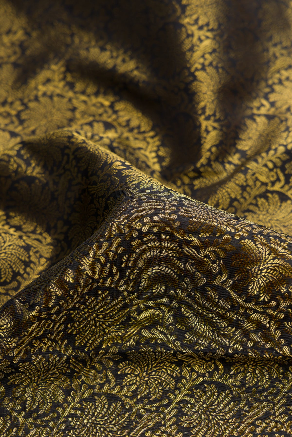 Close up of Pure Silk Pure Zari Black Dual Tone Kanjivaram Saree with Zari Brocade on the body and Zari Border.  displaying folds