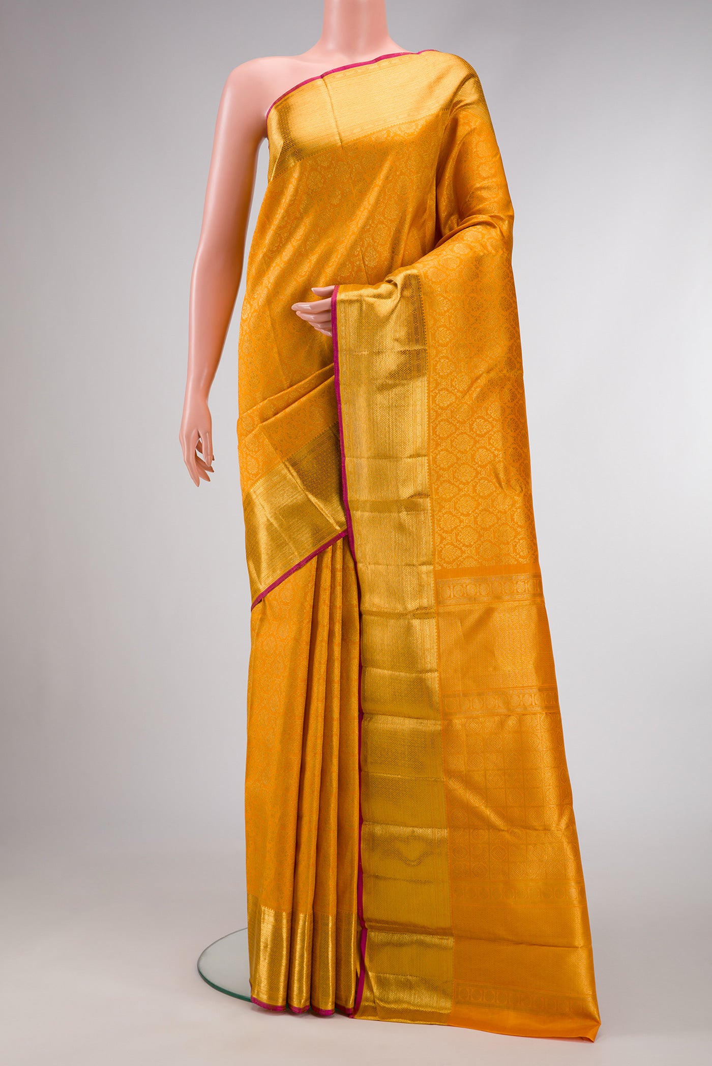 Pure Silk Pure Zari Mustard Dual Tone Kanjivaram Saree with Zari Brocade on the body and Zari Border.  displayed on a mannequin