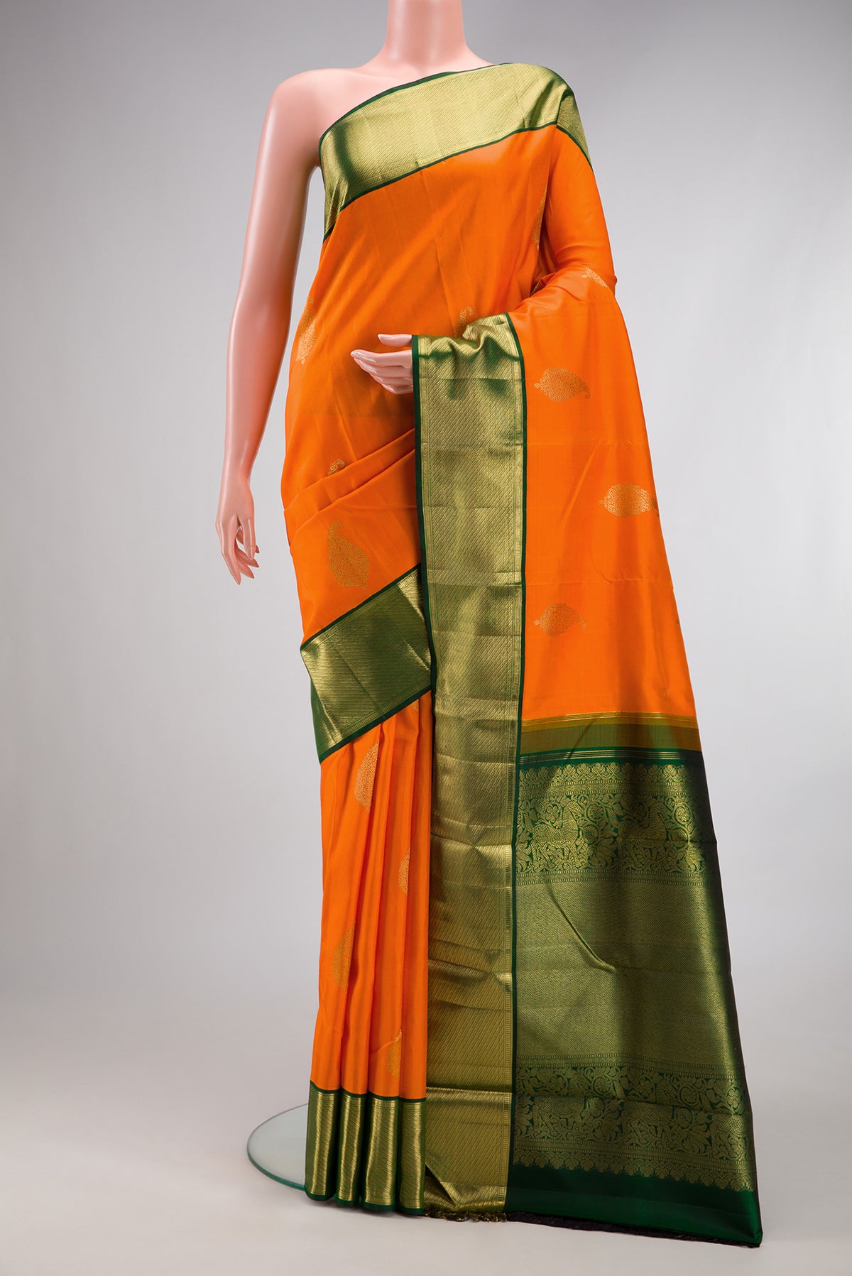 Pure Silk Pure Zari Orange Kanjivaram Saree with Zari Butta on the body and Zari Border.  displayed on a mannequin