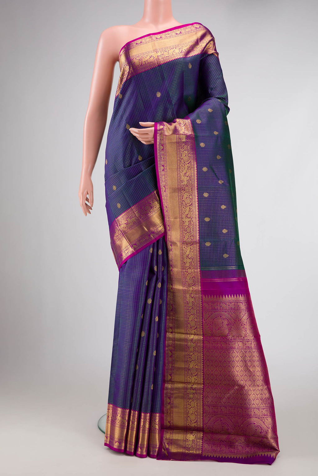 Pure Silk Pure Zari Peacock Blue Dual Tone Kanchipuram Saree with Checked design on the body and Zari Border displayed on a mannequin