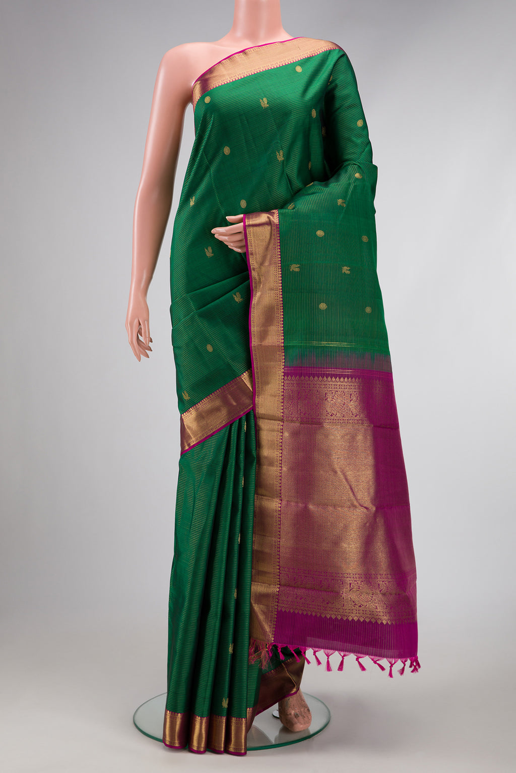 Pure Silk Pure Zari Bottle Green Kanjivaram Saree with Stripes on the body and Zari Border.  displayed on a mannequin