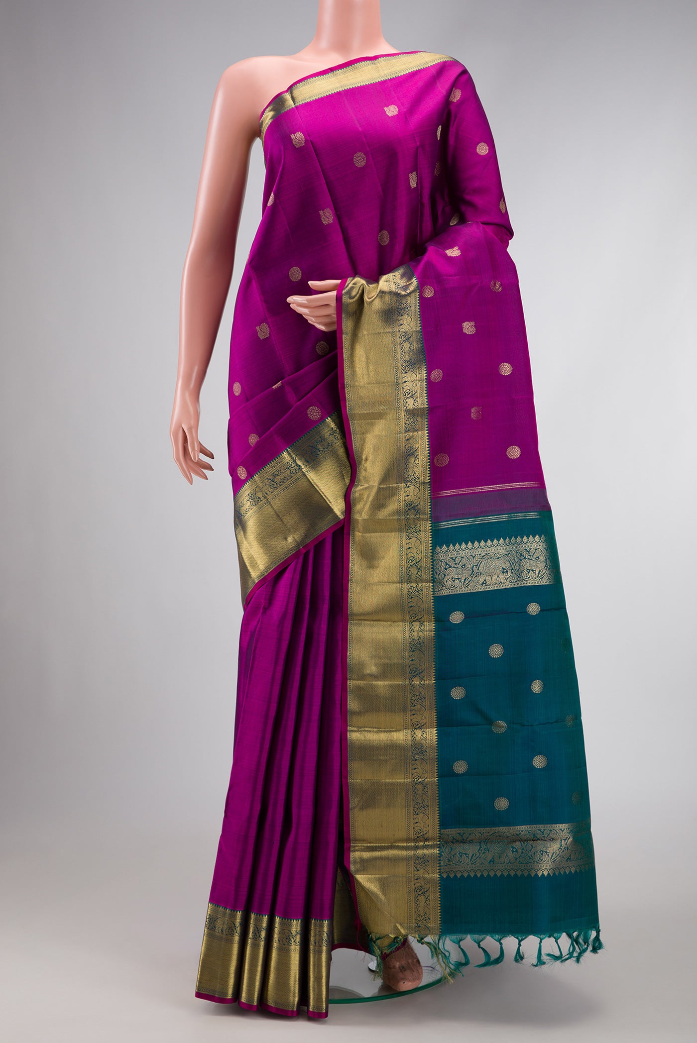 Pure Silk Pure Zari Magenta Dual Tone Kanchipuram Saree with Zari Butta on the body and Zari Border.  displayed on a mannequin