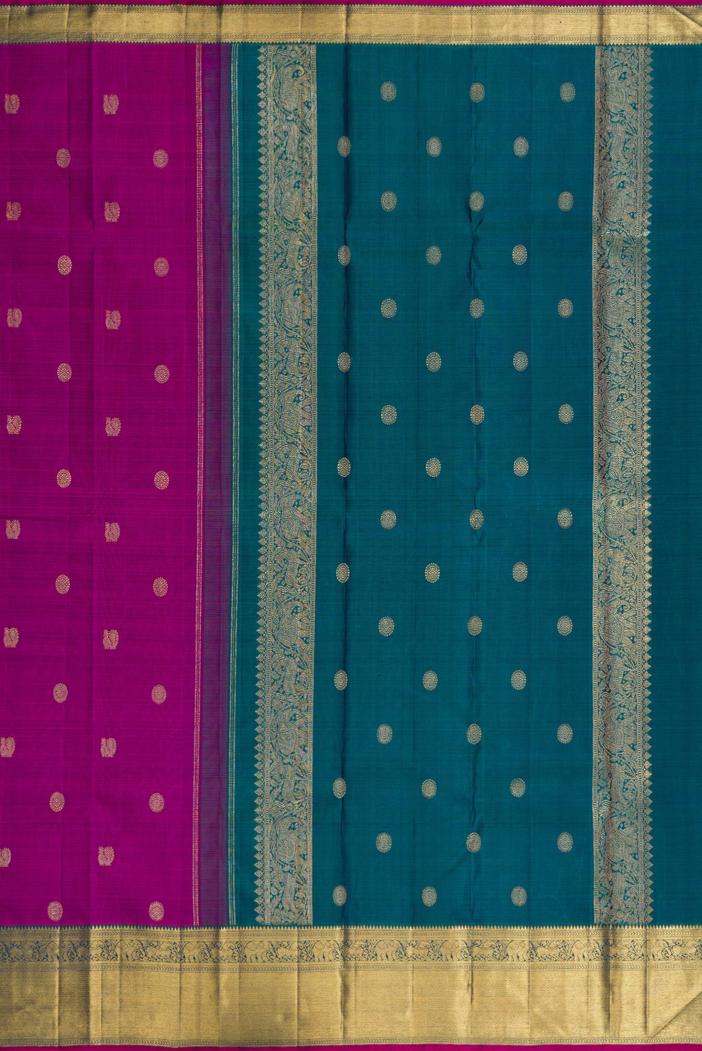 Close up image of the pallu of Pure Silk Pure Zari Magenta Dual Tone Kanchipuram Saree with Zari Butta on the body and Zari Border. 