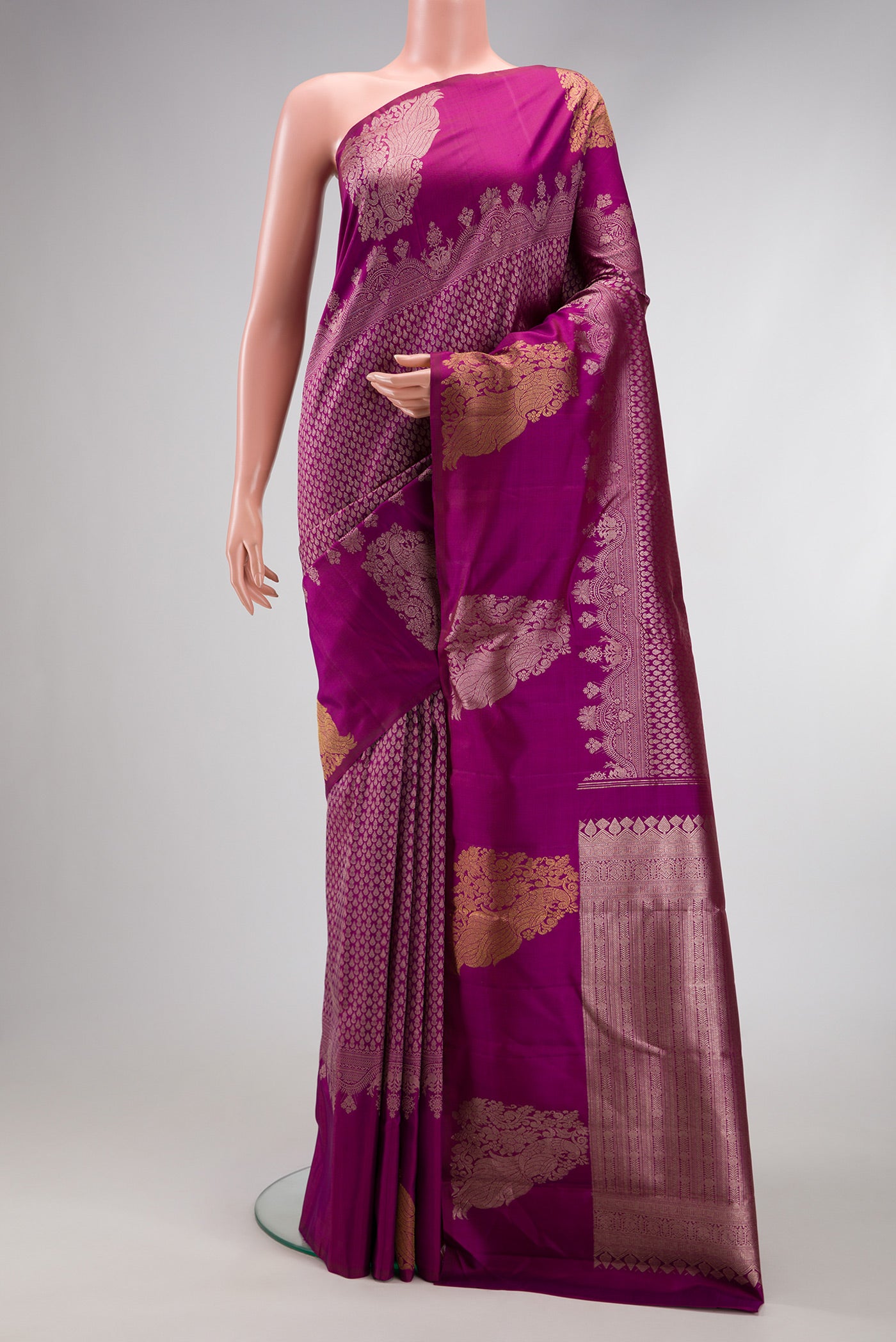 Magenta Kanchipuram Silk Saree with Zari Brocade on the body and Fancy Border.  displayed on a mannequin