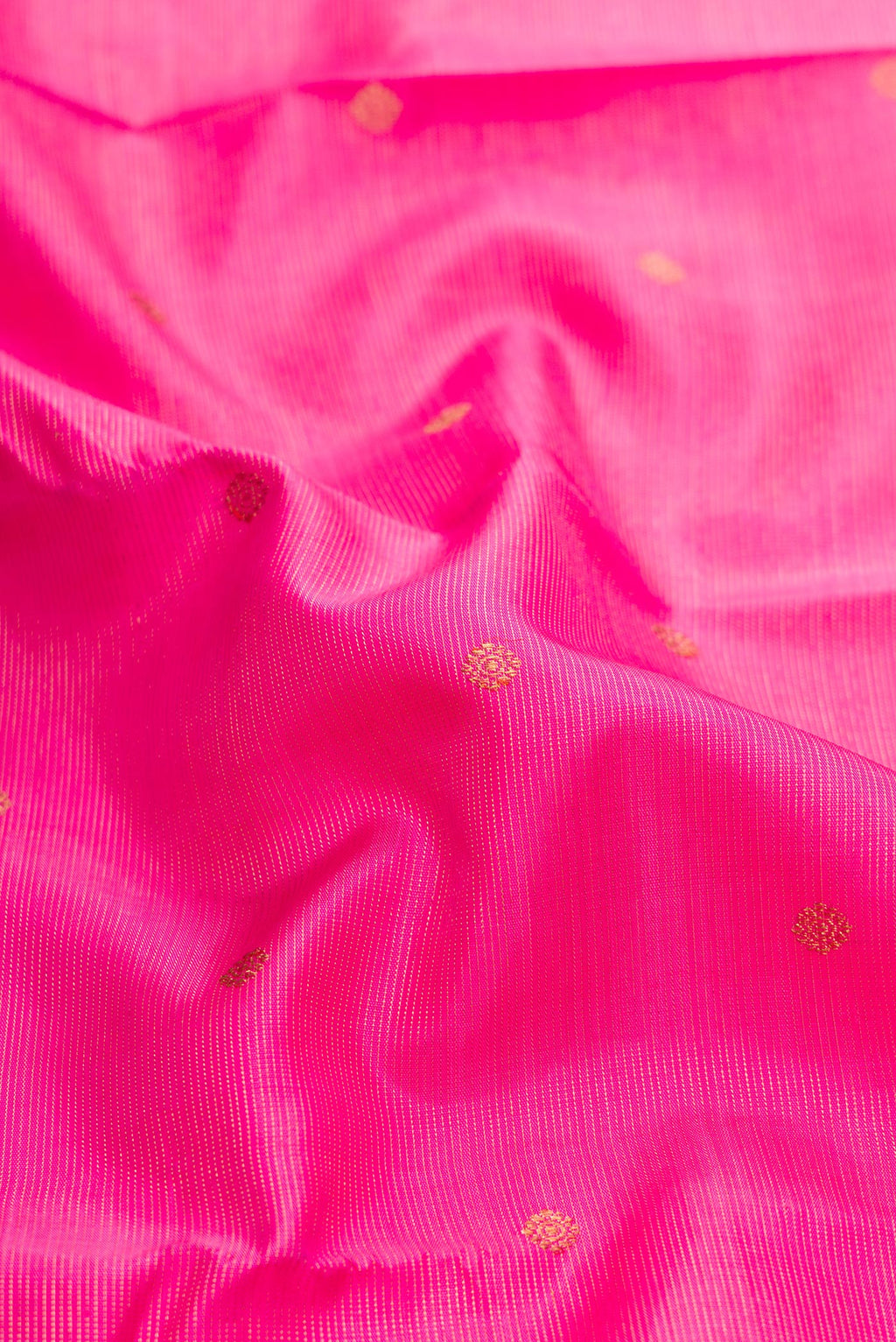 Close up of Pure Silk Pure Zari Pink Dual Tone Kanjivaram Saree with Zari Butta on the body and Zari Border.  displaying folds