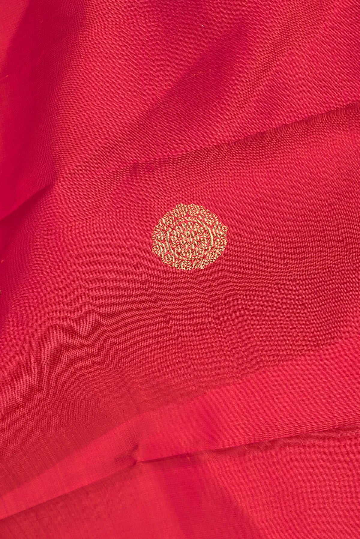 Close up of Pure Silk Pure Zari Red Kanchipuram Saree with Zari Butta on the body and Zari Border.  displaying folds