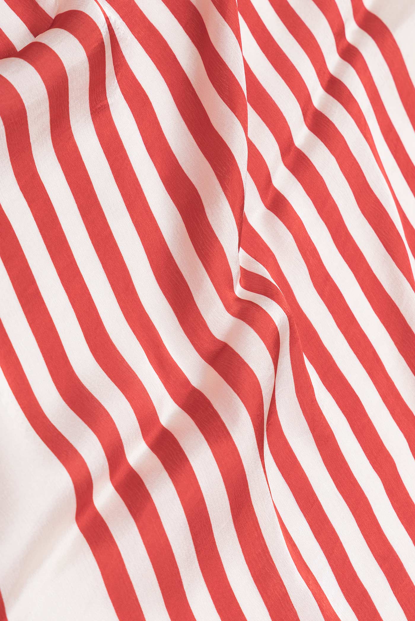 Close up of Red Dual Tone Mysore Crepe Saree with Printed design on the body and Printed Border displaying folds