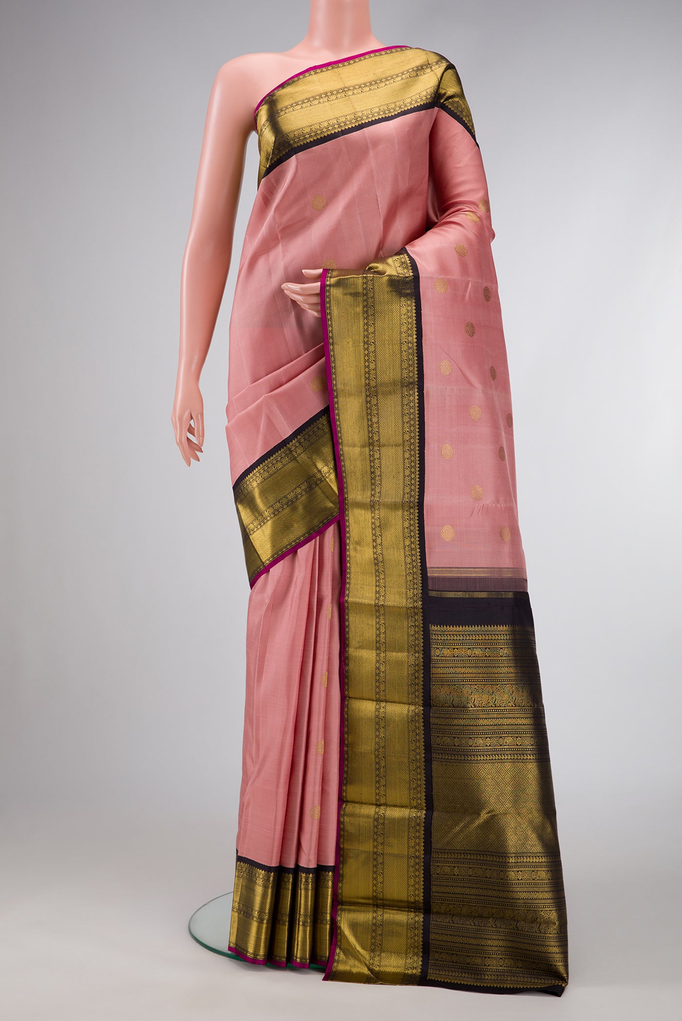 Pure Silk Pure Zari Golden Peach Dual Tone Kanjivaram Saree with Zari Butta on the body and Zari Border.  displayed on a mannequin