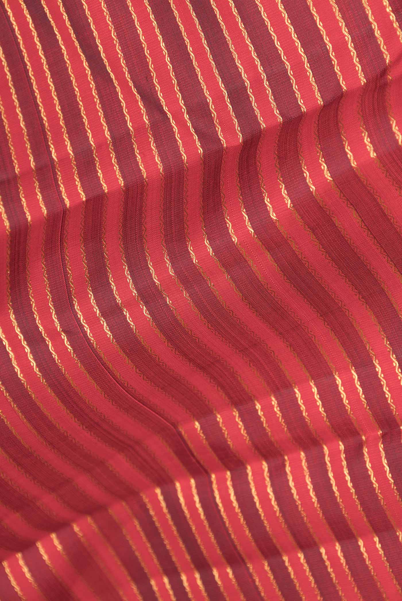 Close up of Pure Silk Pure Zari Red Dual Tone Kanchipuram Saree with Stripes on the body and Zari Border displaying folds