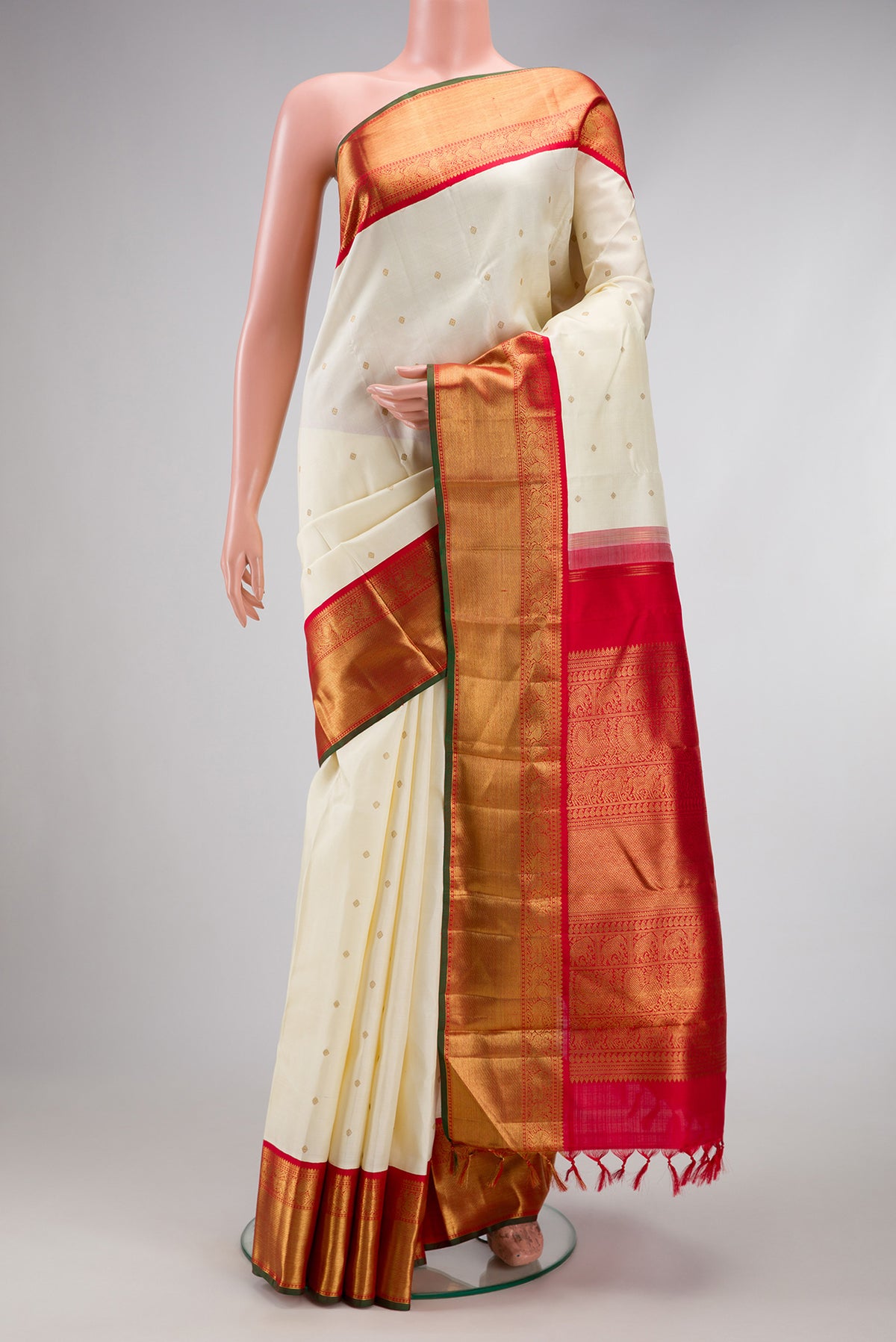 Pure Silk Pure Zari Off White Dual Tone Kanjivaram Saree with Zari Butta on the body and Zari Border.  displayed on a mannequin