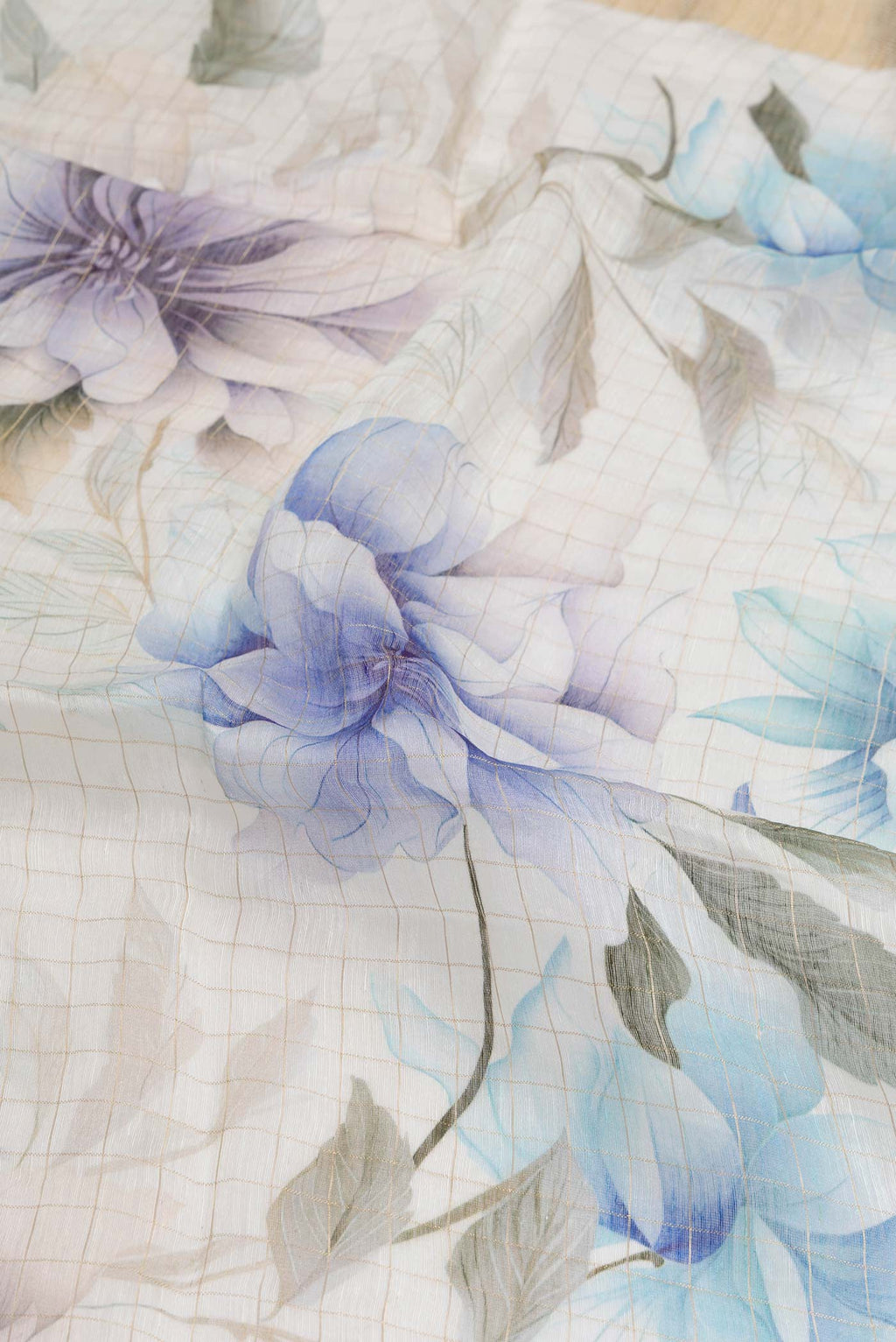 Close up of Beige Dual Tone Linen Saree with Printed design on the body and Zari Border.  displaying folds