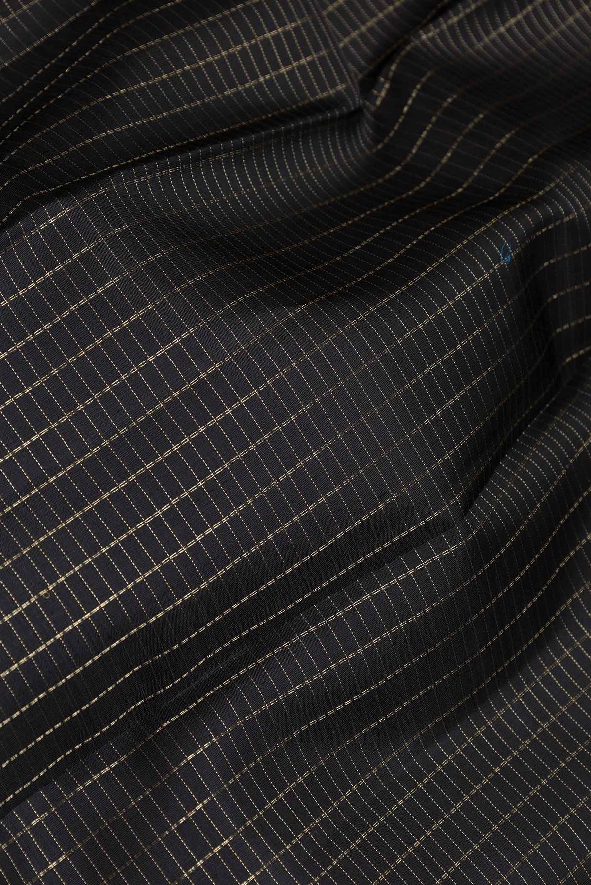 Close up of Pure Silk Pure Zari Black Dual Tone Kanchipuram Saree Checked design on the body and Zari Border displaying folds