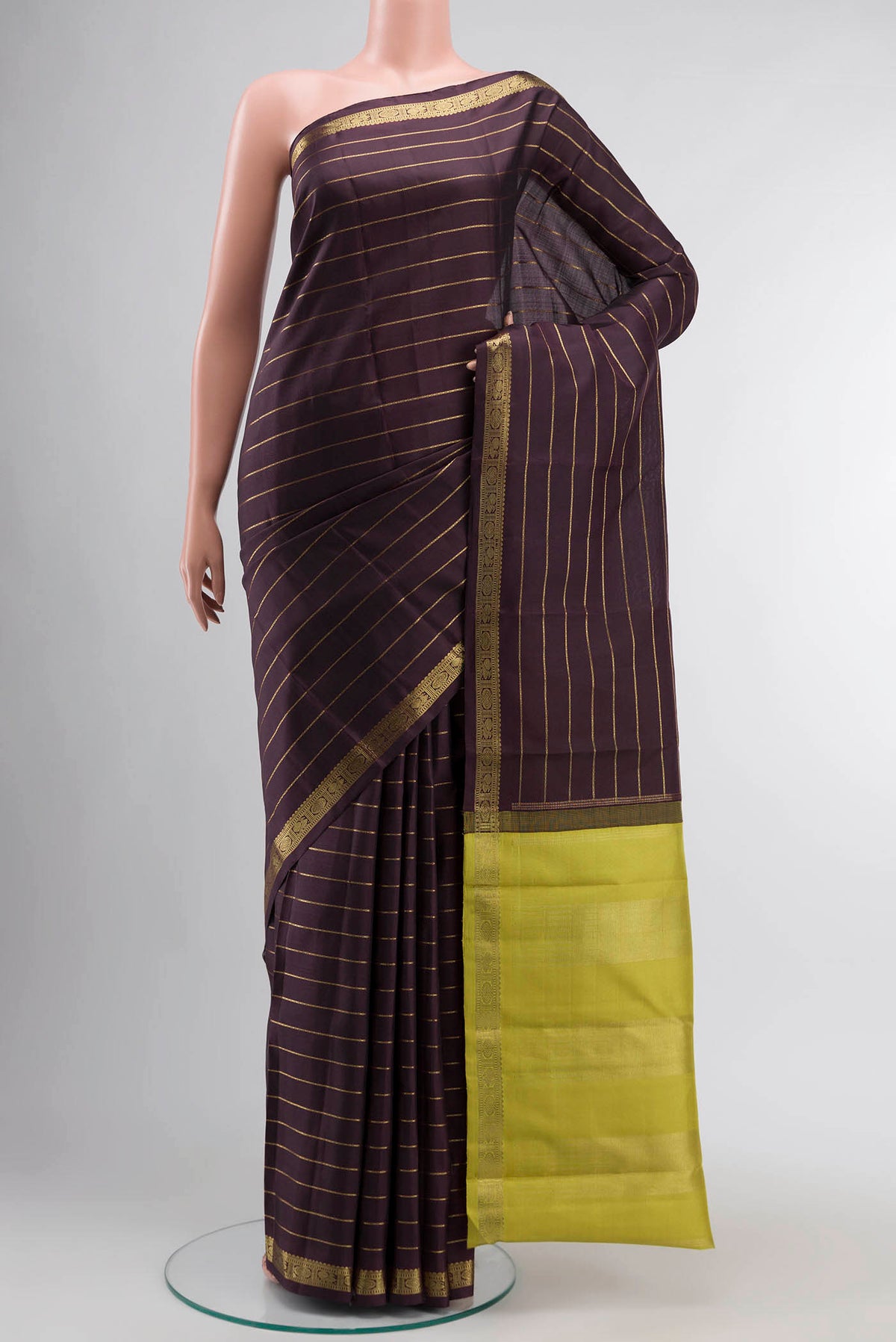 Brown Kanchipuram Silk Saree with Stripes on the body and Zari Border displayed on a mannequin