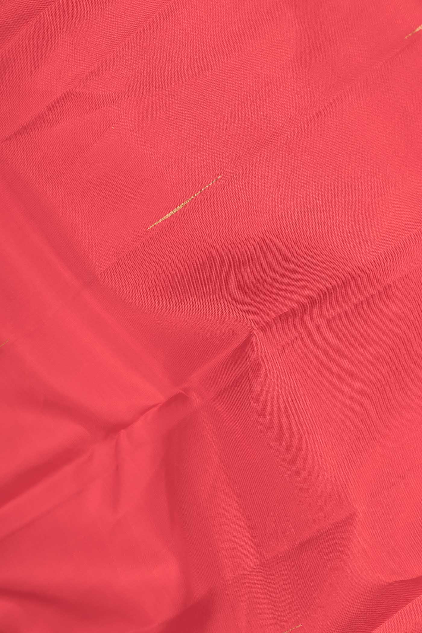 Close up of Pure Silk Pure Zari Red Dual Tone Kanchipuram Saree with Zari Butta on the body and Fancy Border displaying folds