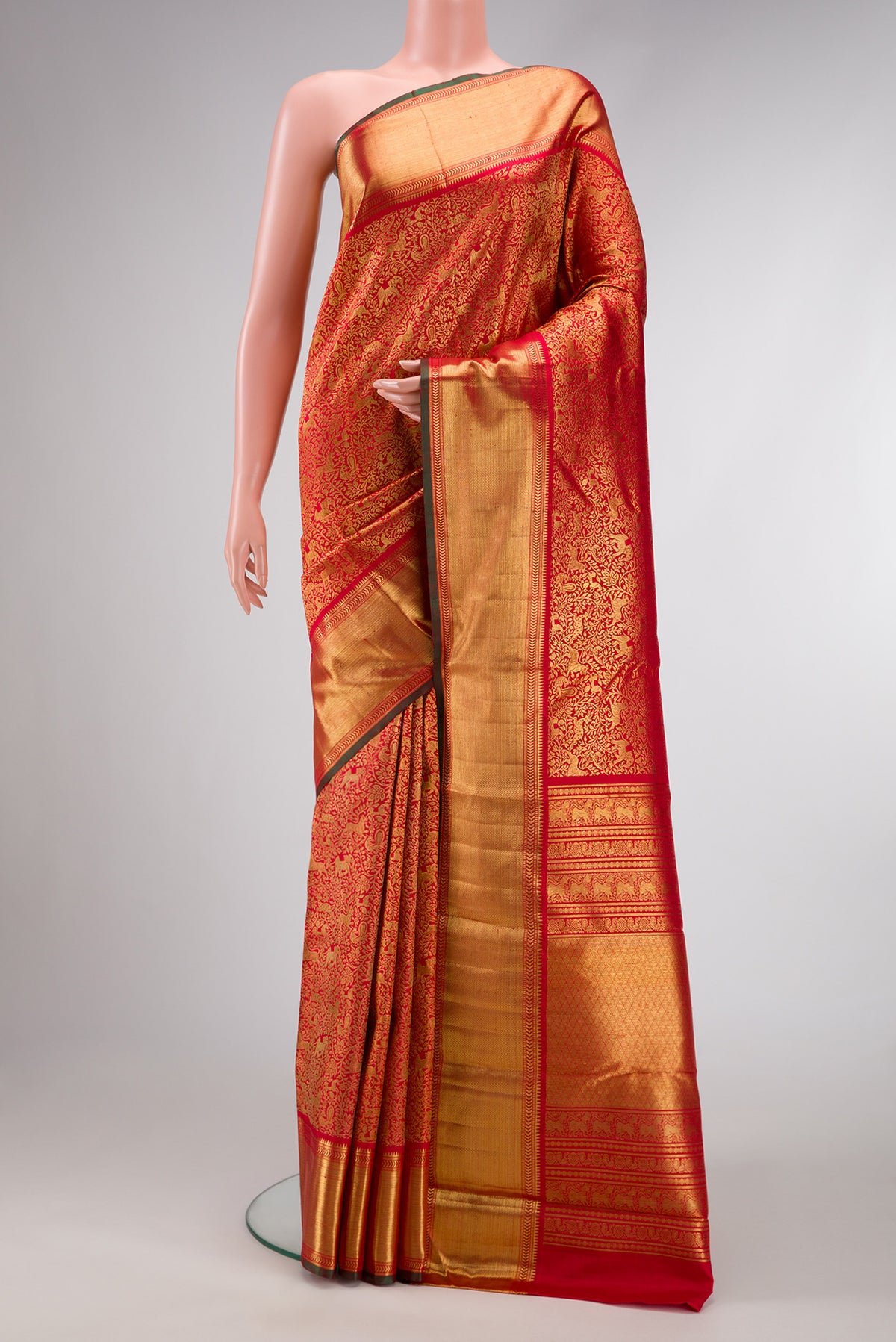 Pure Silk Pure Zari Red Dual Tone Kanjivaram Saree with Zari Brocade on the body and Zari Border.  displayed on a mannequin