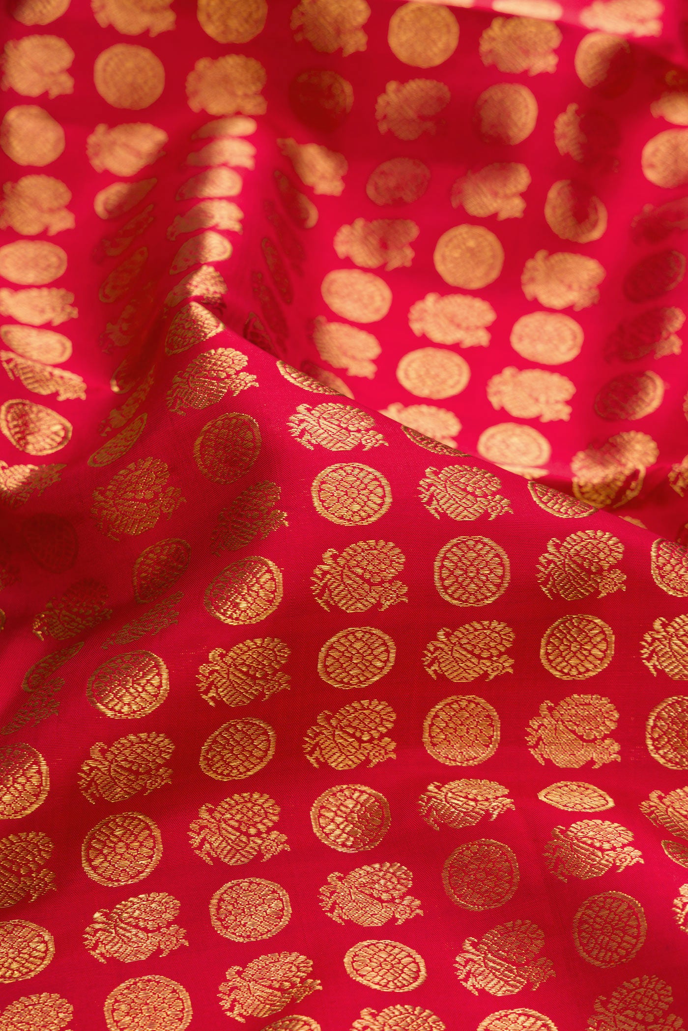 Close up of Pure Silk Pure Zari Red Dual Tone Kanjivaram Saree with Zari Brocade on the body and Zari Border.  displaying folds