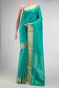 Sea Green Dual Tone Soft Silk Saree with Zari Butta on the body and Zari Border.  displayed on a mannequin