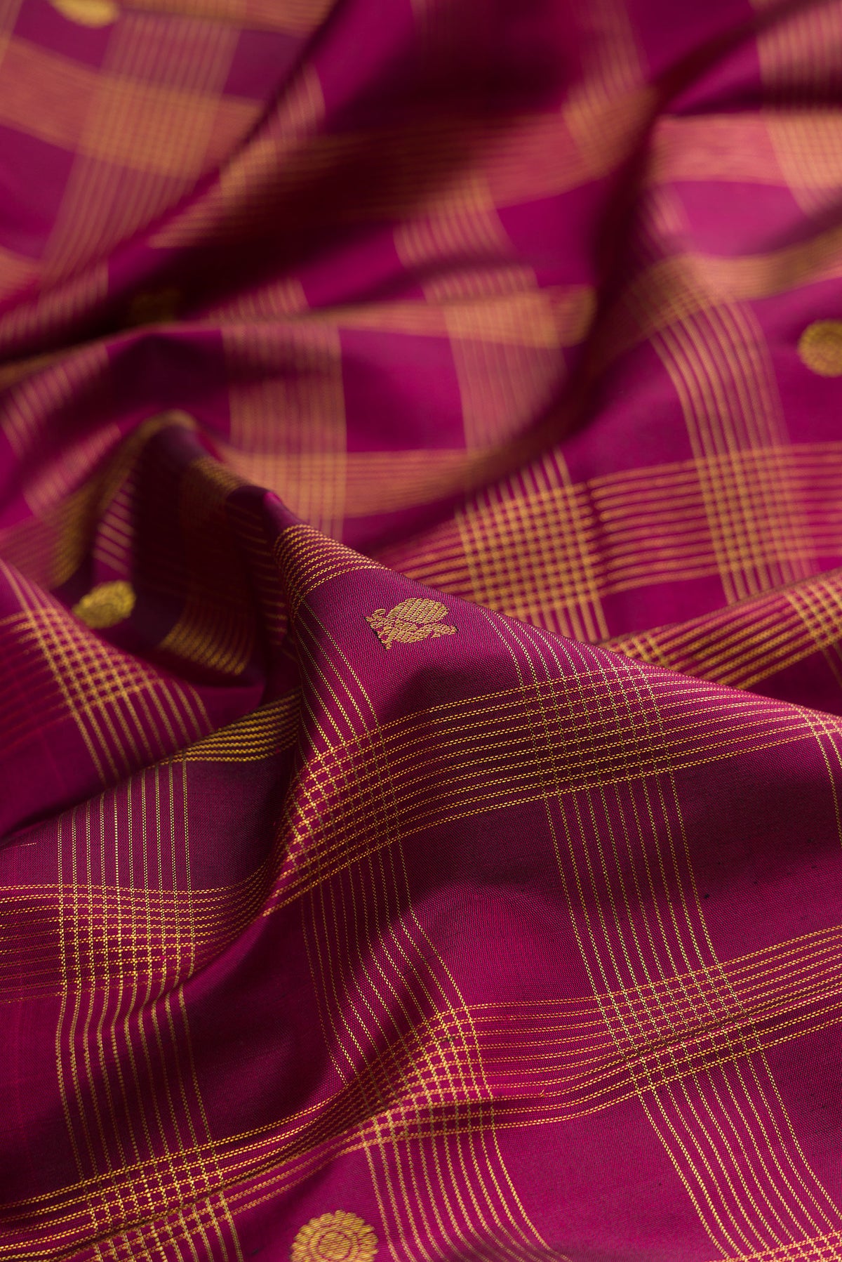 Close up of Pure Silk Burgundy Kanjivaram Saree with Checked design on the body and Zari Border.  displaying folds