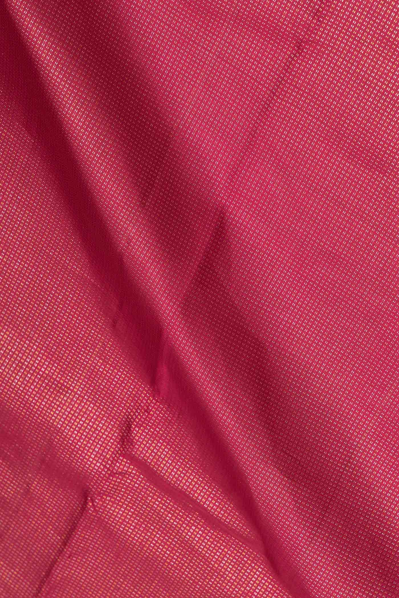 Close up of Maroon Dual Tone Kanchipuram Saree with Stripes on the body and Plain Border.  displaying folds