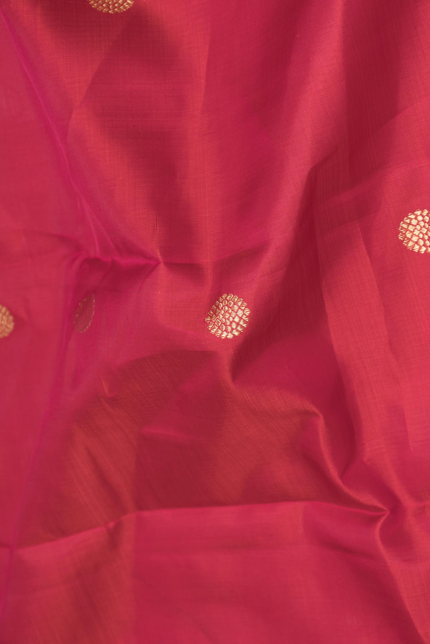 Close up of Maroon Dual Tone Kanchipuram Saree with Zari Butta on the body and Zari Border displaying folds