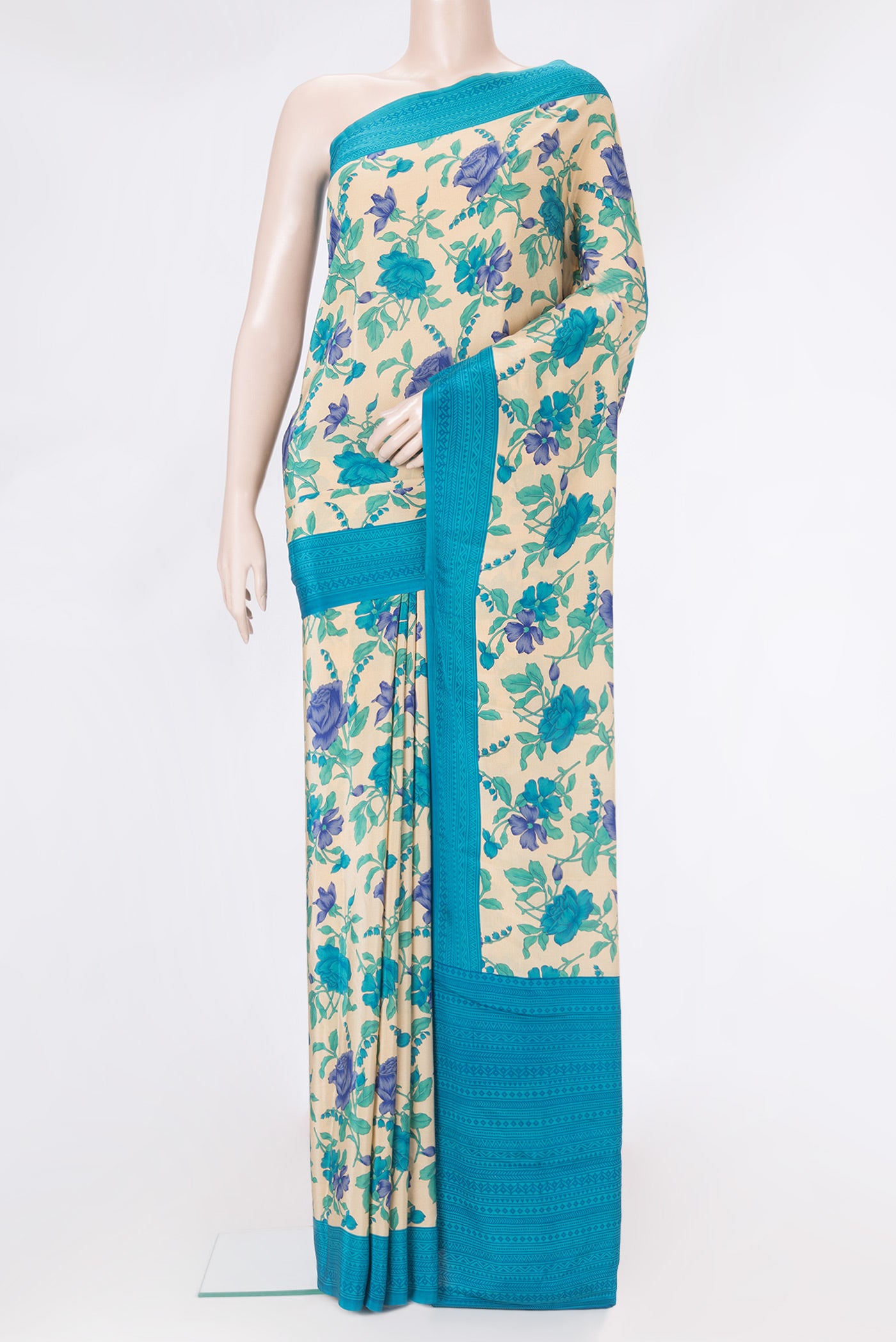 Beige Crepe Saree with Floral Print on the body and Printed Border.  displayed on a mannequin