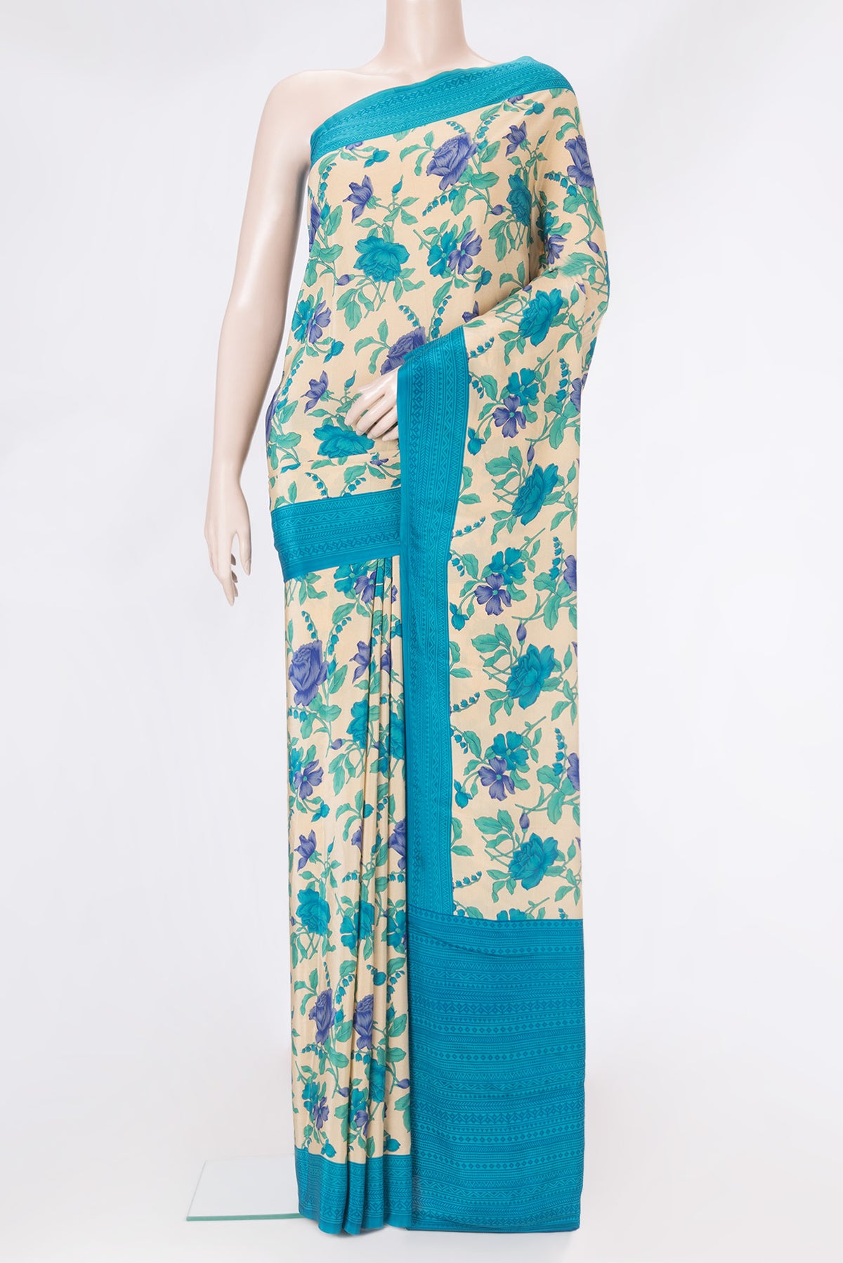 Beige Crepe Saree with Floral Print on the body and Printed Border.  displayed on a mannequin