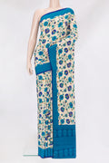 Beige Crepe Saree with Printed design on the body and Printed Border.  displayed on a mannequin