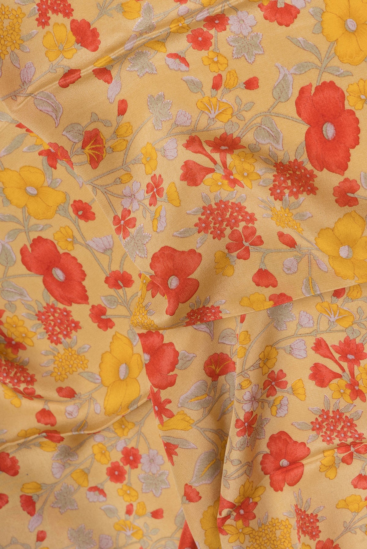 Close up of Sandal Crepe Saree with Floral Print on the body and Printed Border.  displaying folds