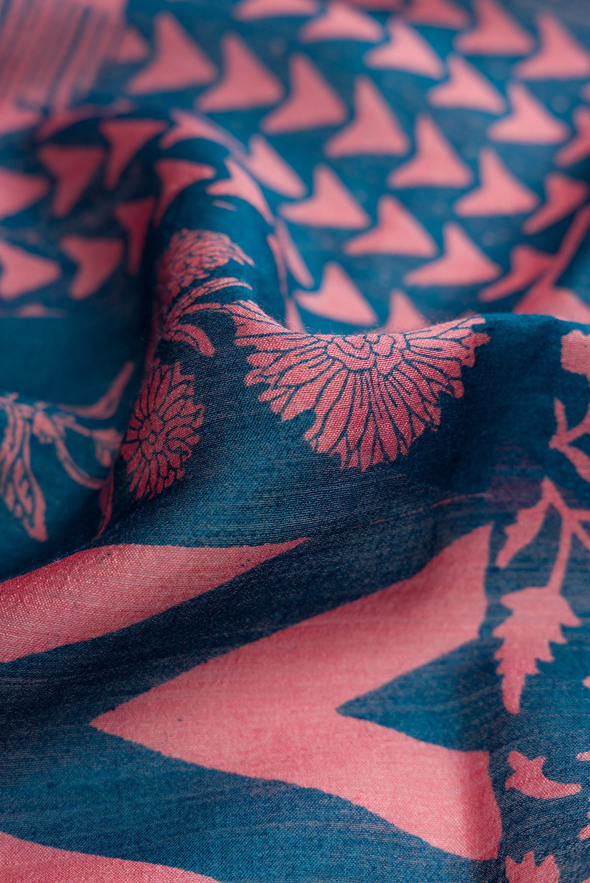 Close up of Peacock Blue Dual Tone Tussar Silk Saree with Printed design on the body and Zari Border.  displaying folds