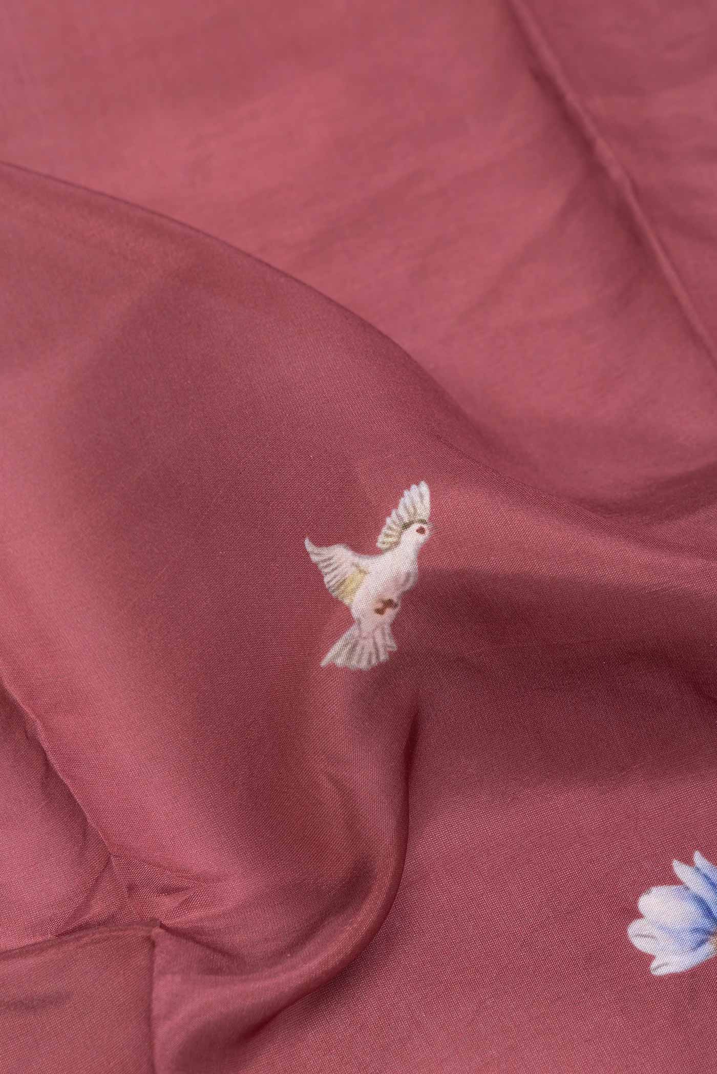 Close up of Maroon Dual Tone Tussar Silk SareePrinted design on the body and Zari Border displaying folds