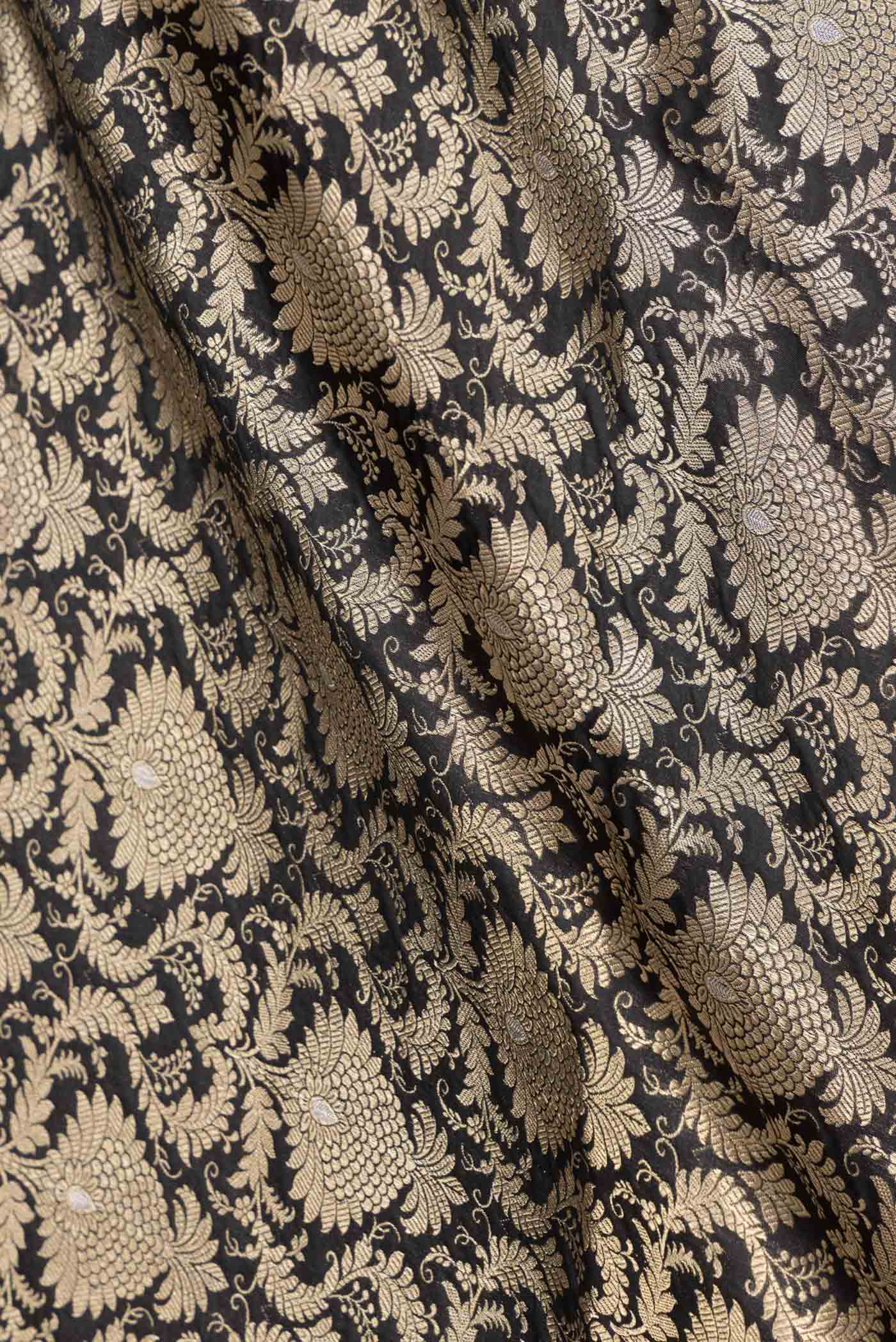 Close up of Black Dual Tone Banarasi Silk Saree with Zari Brocade on the body and Zari Border displaying folds