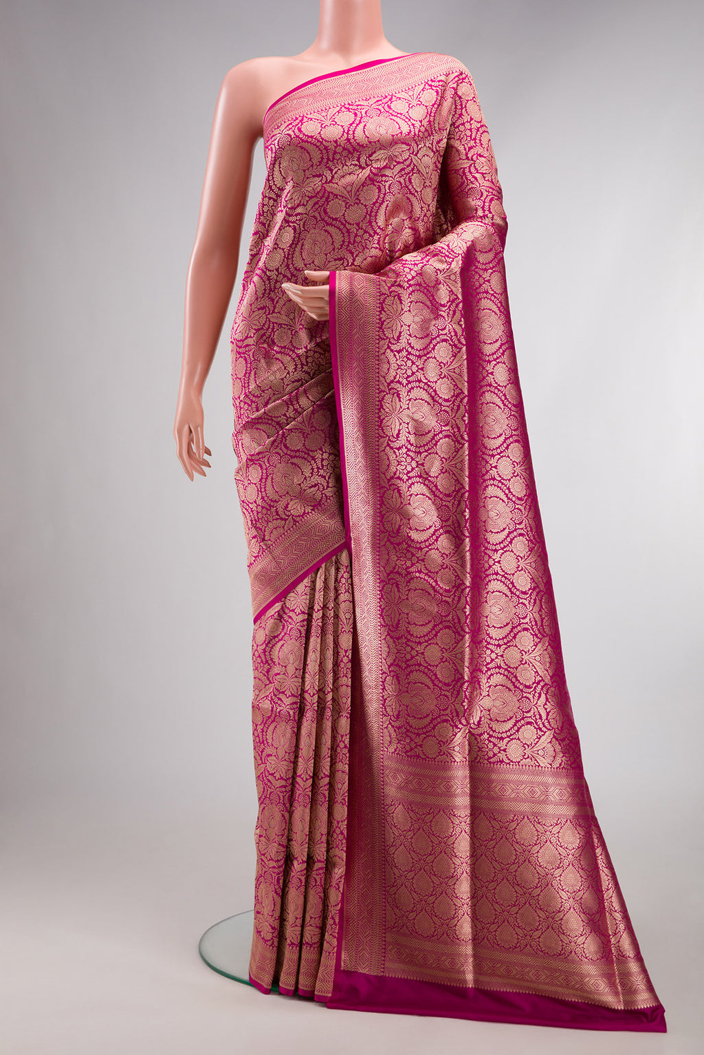 Magenta Banarasi Silk Saree with Zari Brocade on the body and Fancy Border.  displayed on a mannequin