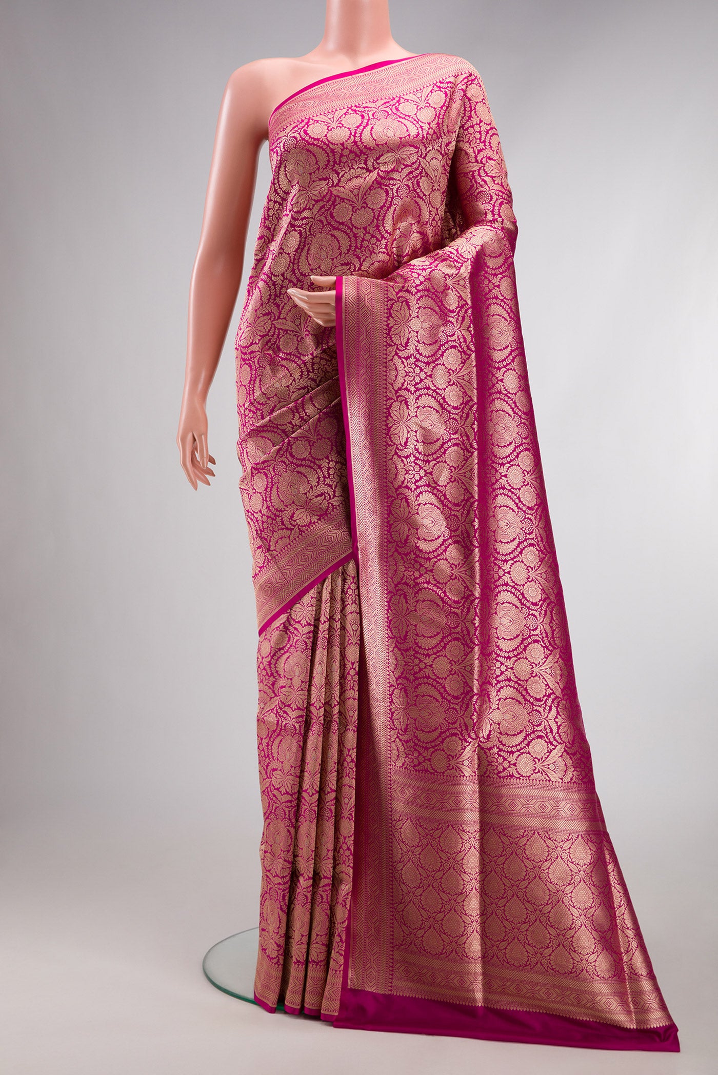 Magenta Banarasi Silk Saree with Zari Brocade on the body and Fancy Border.  displayed on a mannequin