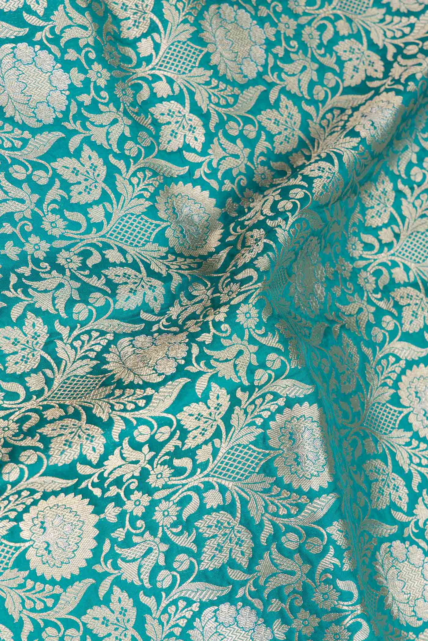 Close up of Green Dual Tone Banarasi Silk Saree with Zari Brocade on the body and Zari Border displaying folds