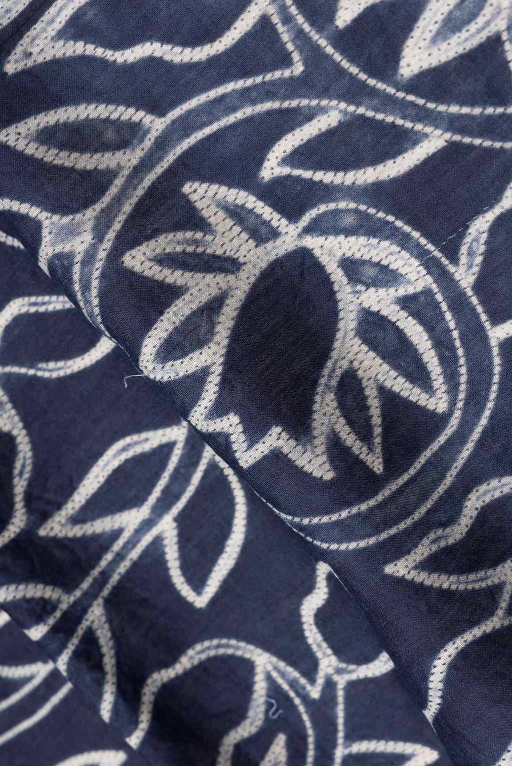 Close up of Navy Blue Dual Tone Tussar Saree with Printed design on the body and Printed Border.  displaying folds